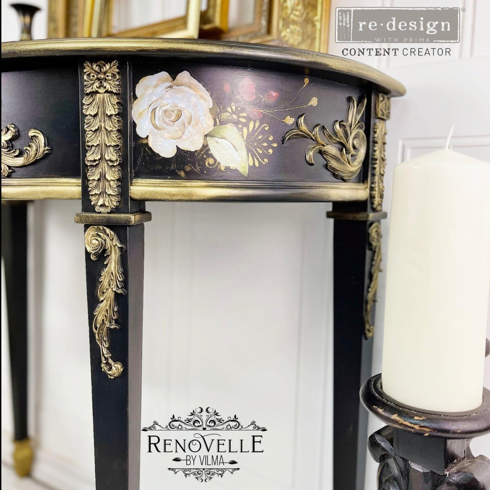 A close-up of a vintage half circle entryway table refurbished by Renovelle by Vilma is painted black with gold accents and features ReDesign with Prima's Midnight Floral transfer on the sides.