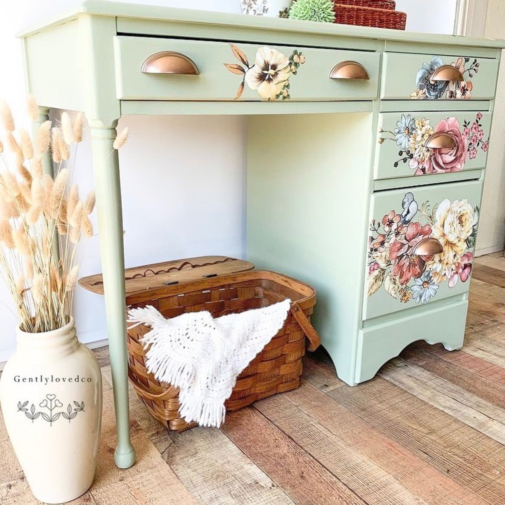 A vintage desk refurbished by Gently Loved Company is painted pale green and features ReDesign with Prima's Ruby Rose rub-on transfer on its 4 drawers.