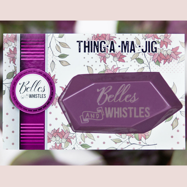 Belles & Whistles Thing-a-ma-jig angled squeegee package with a light mauve border on the top and bottom on the photo.
