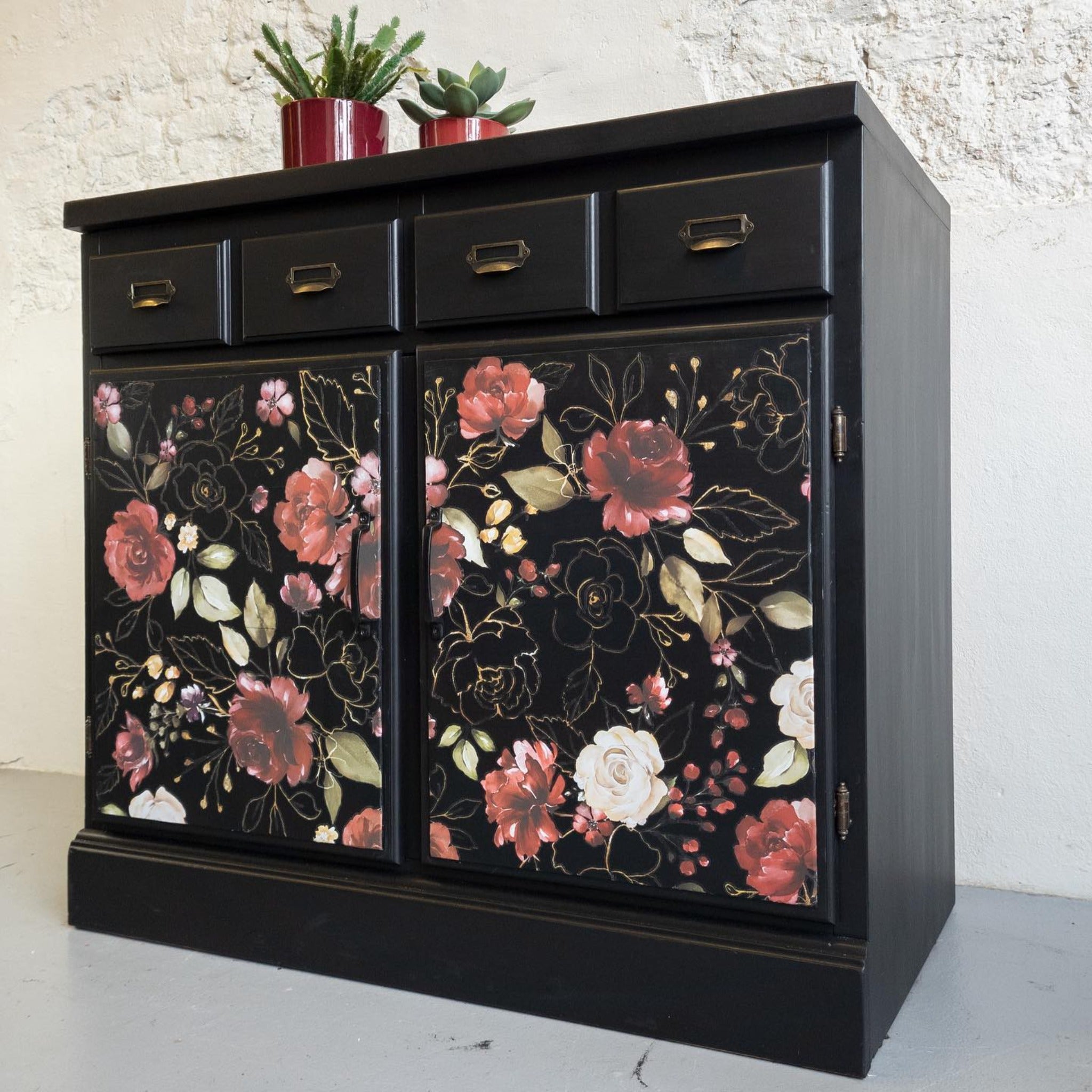 A vintage small buffet table with 4 small drawers and 2 large doors is painted black and features ReDesign with Prima's Midnight Floral transfer on the doors.