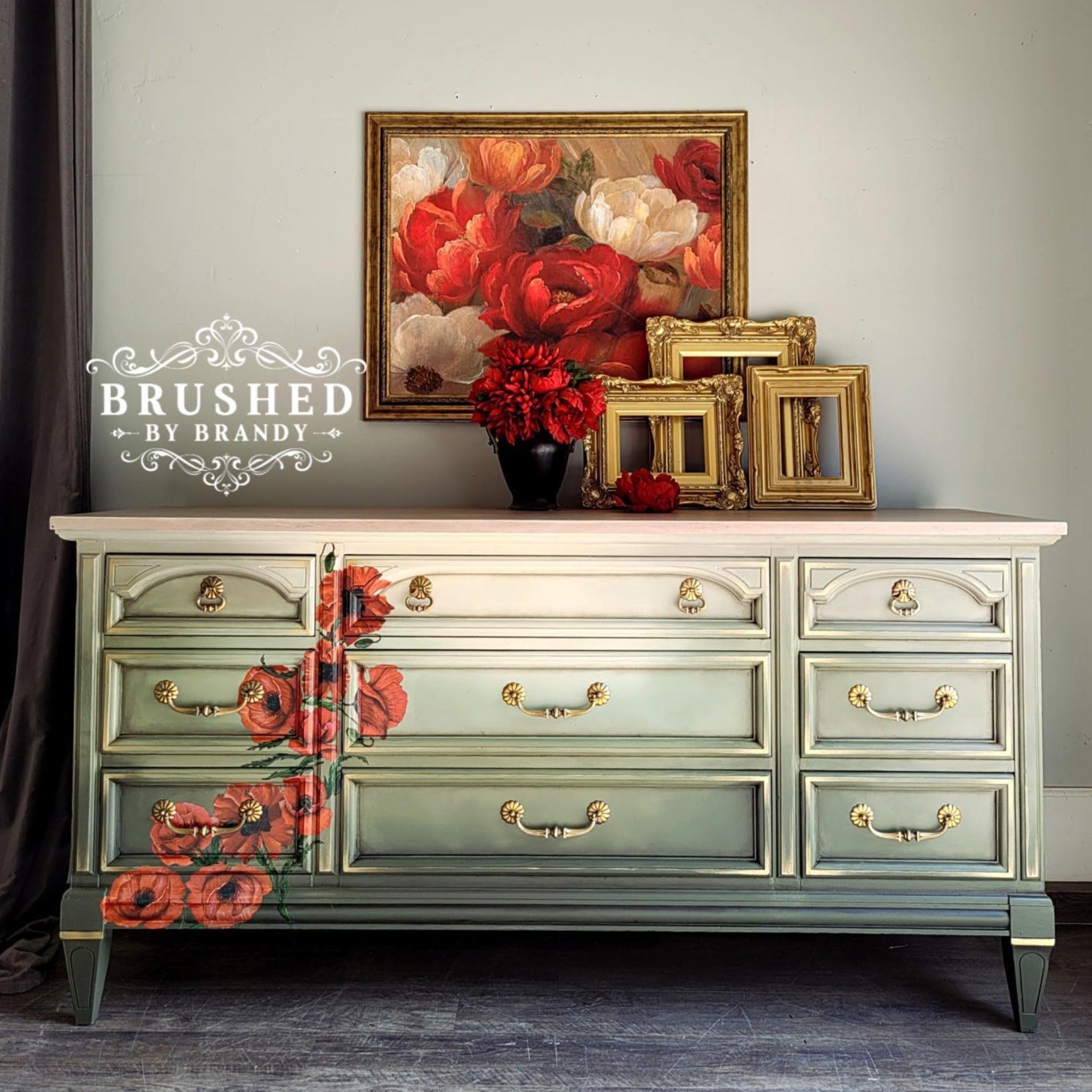 A large vintage dresser refurbished by Brushed by Brandy is painted an ombre of white down to dark green and features ReDesign with Prima's Poppy Gardens transfer on the left side drawers.