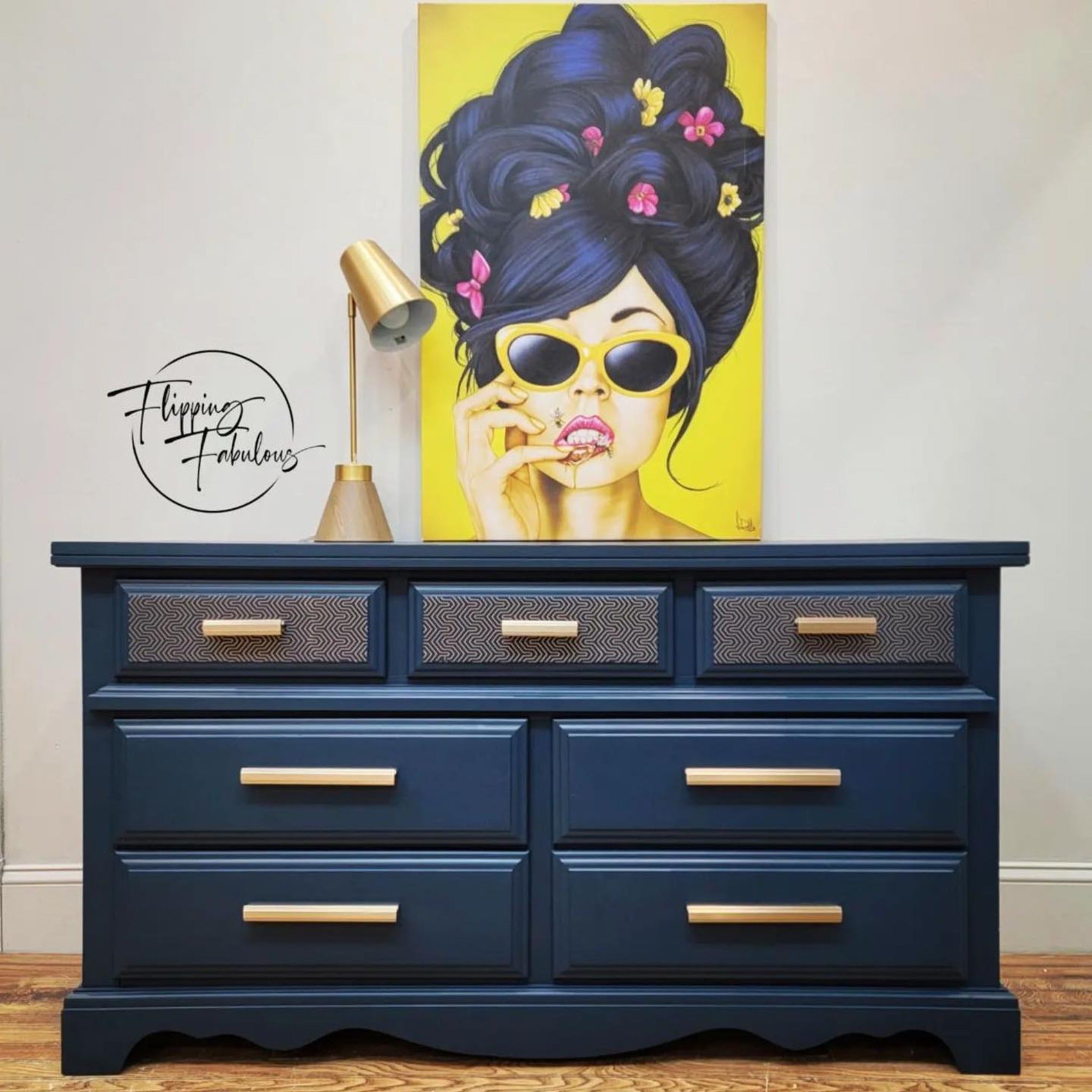 A 7-drawer dresser refurbished by Flipping Fabulous is painted blue and features ReDesign with Prima's Motif Geometrique small transfer on its top 3 small drawers.