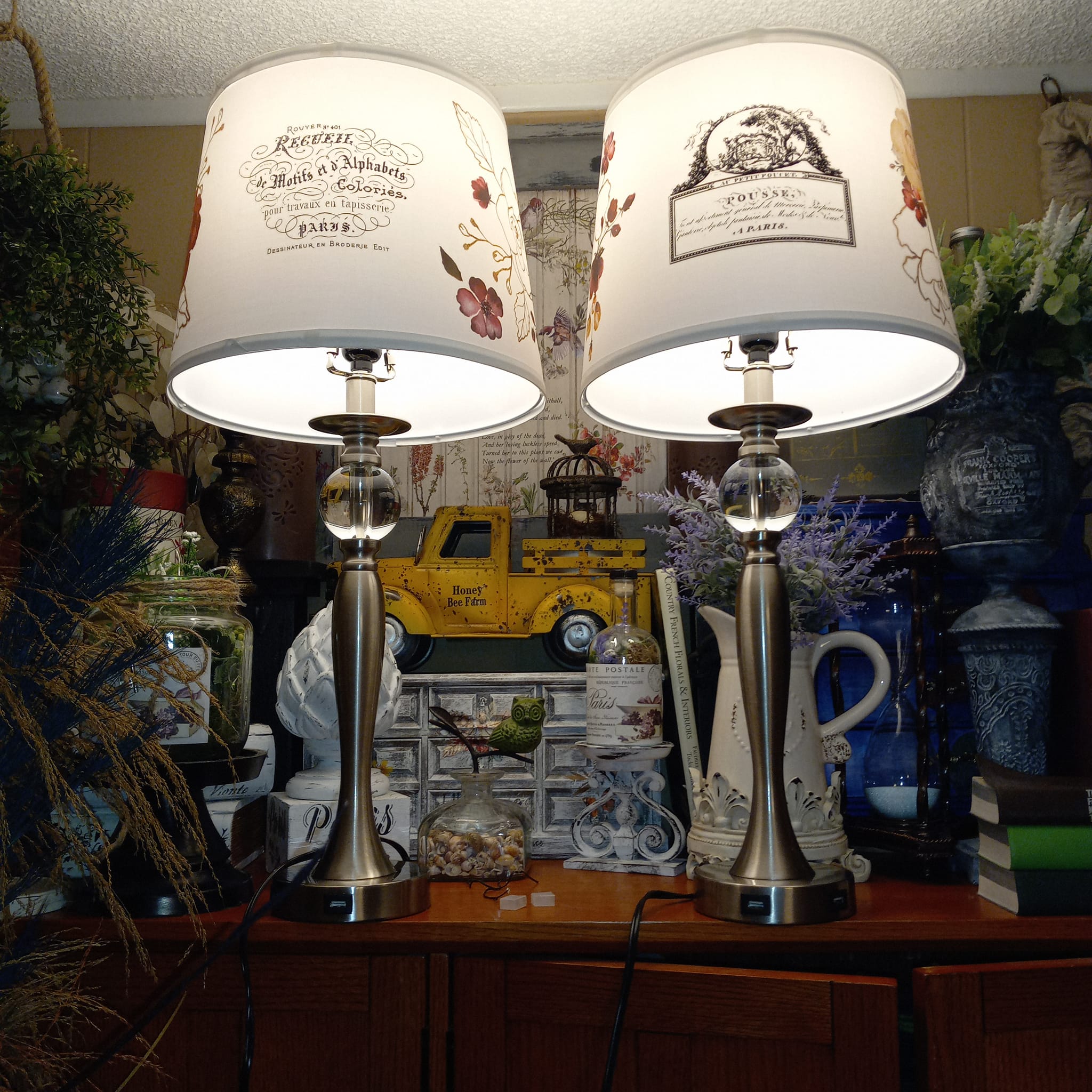 Two smll table lamps refurbished by Xa Hughes feature ReDesign with Prima's Classic Vintage Labels on their white lampshades.
