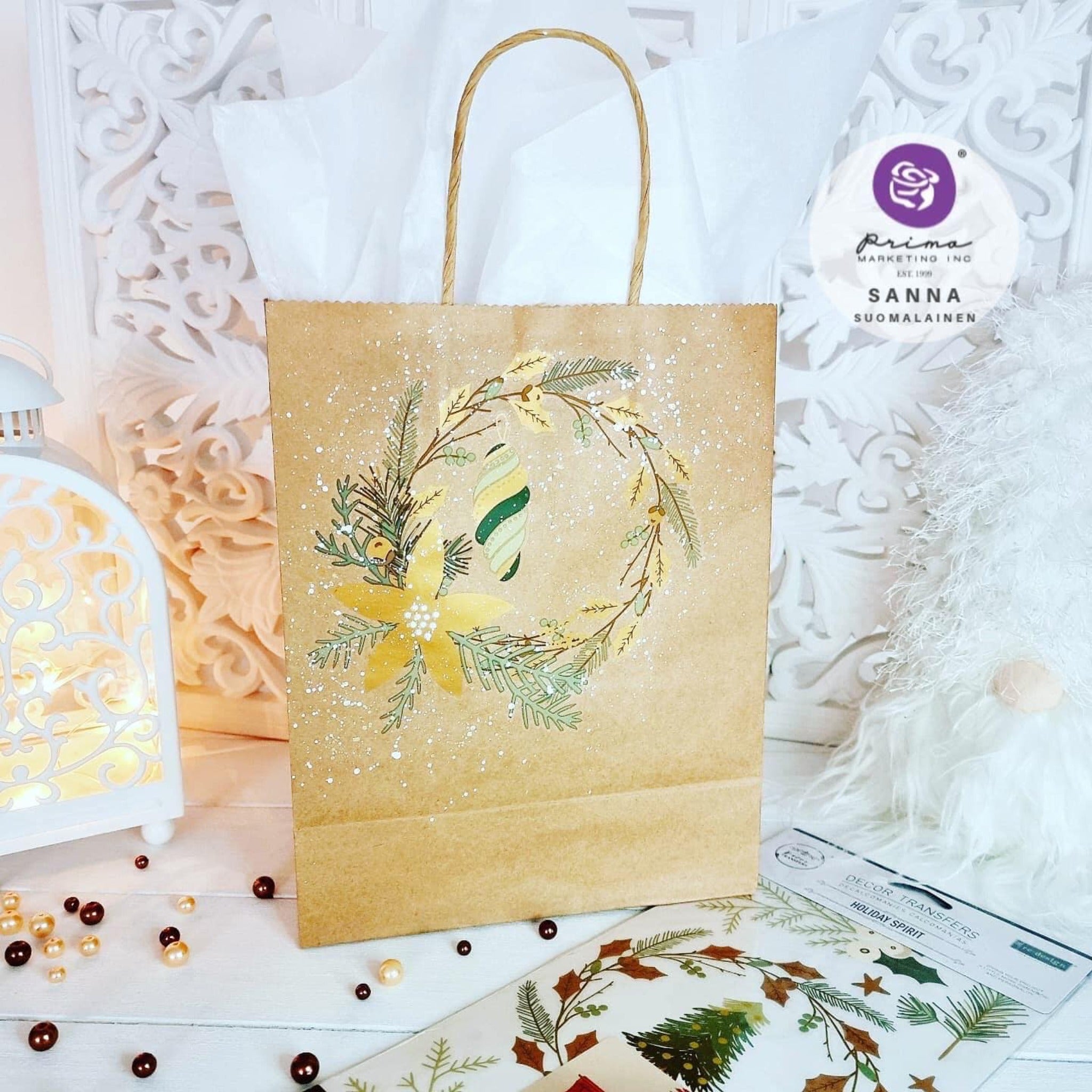 A brown gift bag decorated by Sanna Suomalainen features ReDesign with Prima's Holiday Spirit small transfer on it.