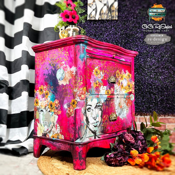 A corner side view of a 2-drawer nightstand refurbished by CeCe ReStyled is painted bright pink and features ReDesign with Prima's Abstract Beauty tissue paper on it.