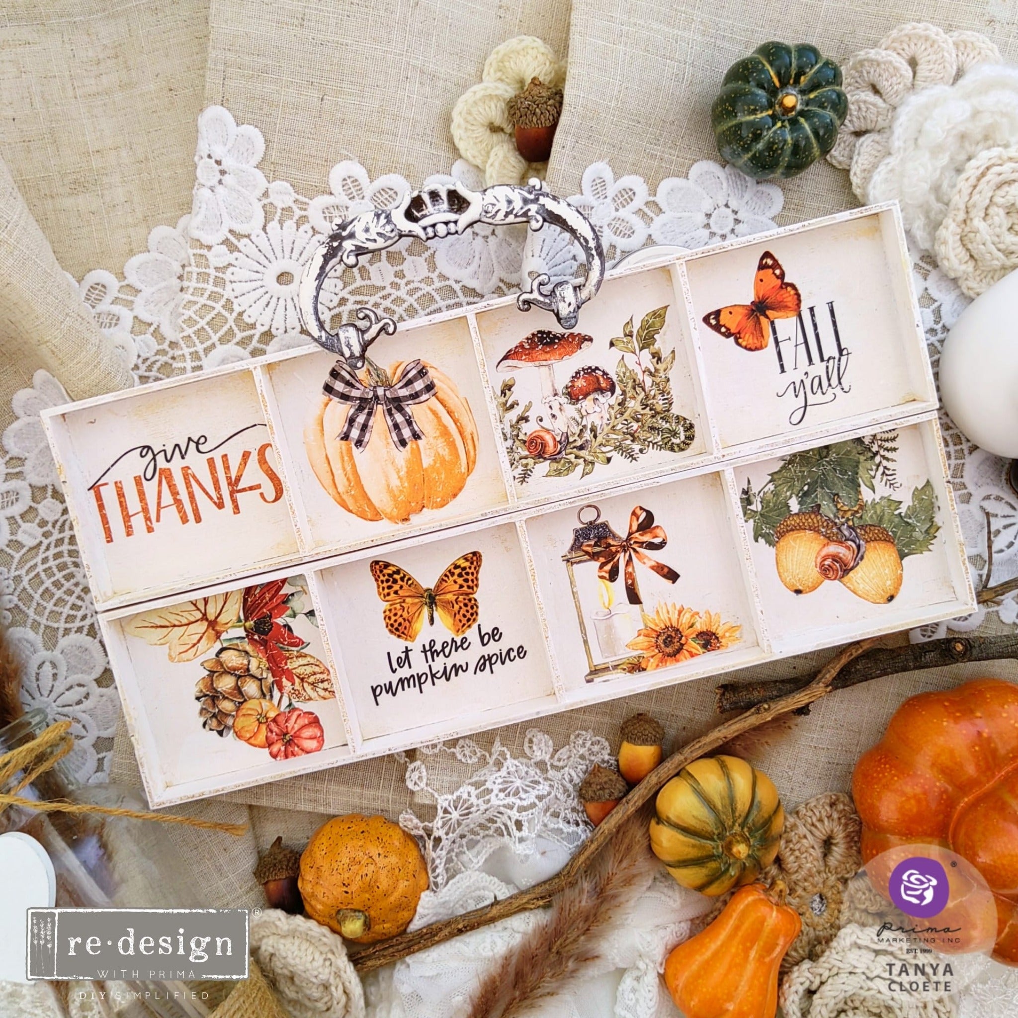 A printer's tray refurbished by Tanya Cloete is painted soft white and features ReDesign with Prima's Autumn Essentials small transfer inside all 8 cubby holes.