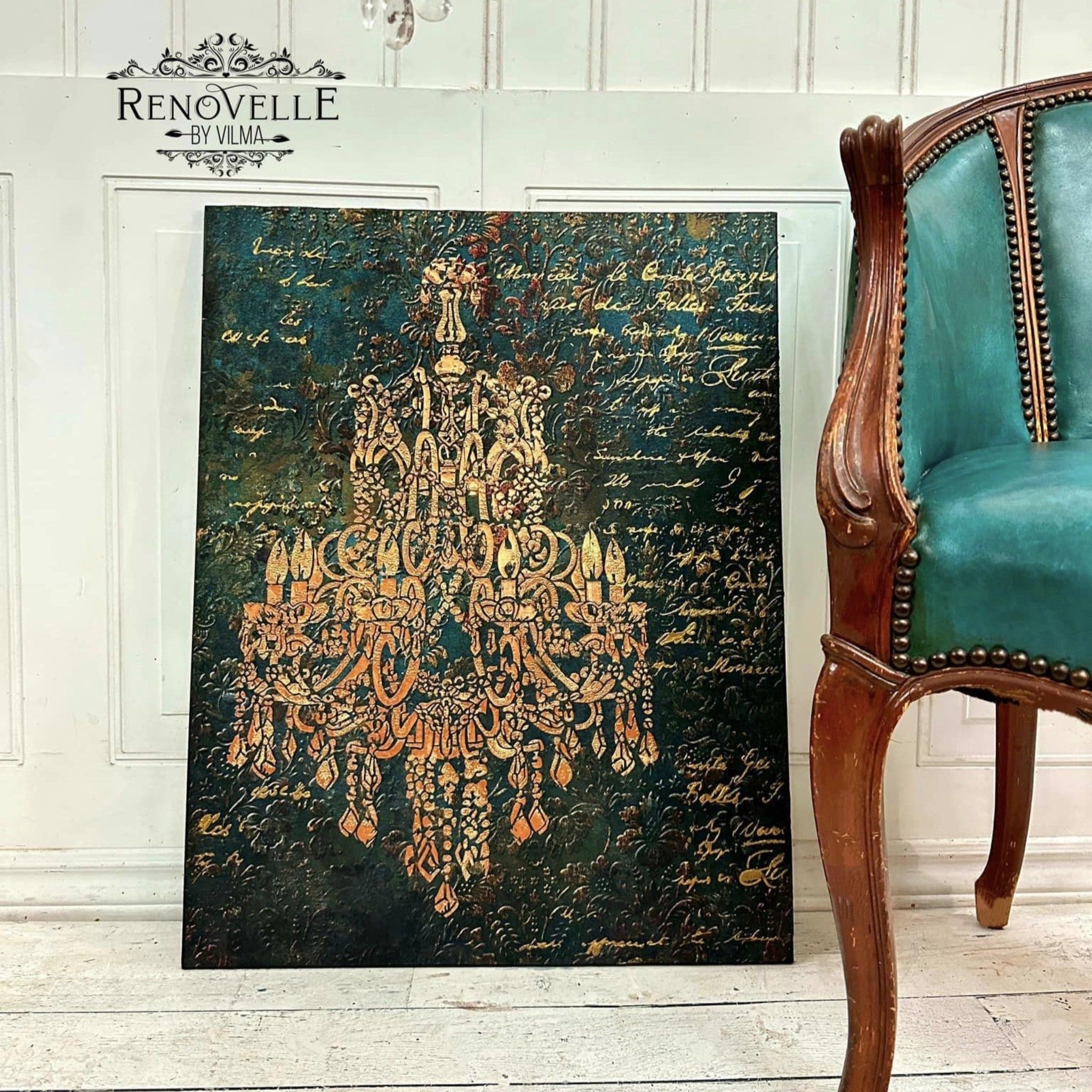 A canvas created by Renovelle by Vilma features ReDesign with Prima's Aged Patina A1 fiber paper. A stencil design of a crystal chandelier in gold color is featured over the fiber paper.
