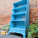 A vintage hutch top turned into a bookcase is painted sky blue and features ReDesign with Prima's Blossom Botanica on its backboard.
