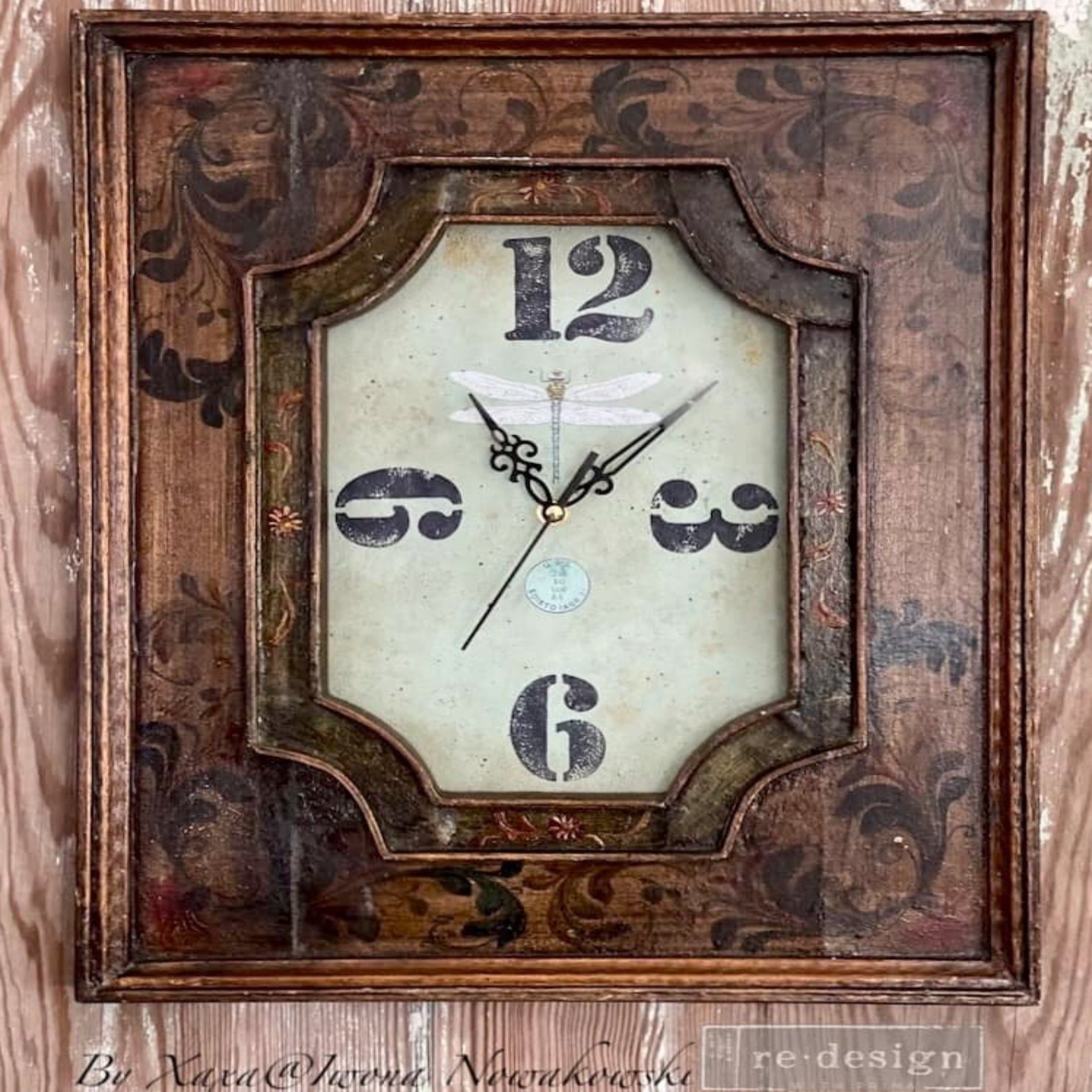 A vintage wood picture frame turned into a clock refurbished by Iwona Nowakowski and features ReDesign with Prima's Spring Dragonfly small transfer inside the glass in the middle of the 4 large 12, 3, 6, and 9 hour numbers.