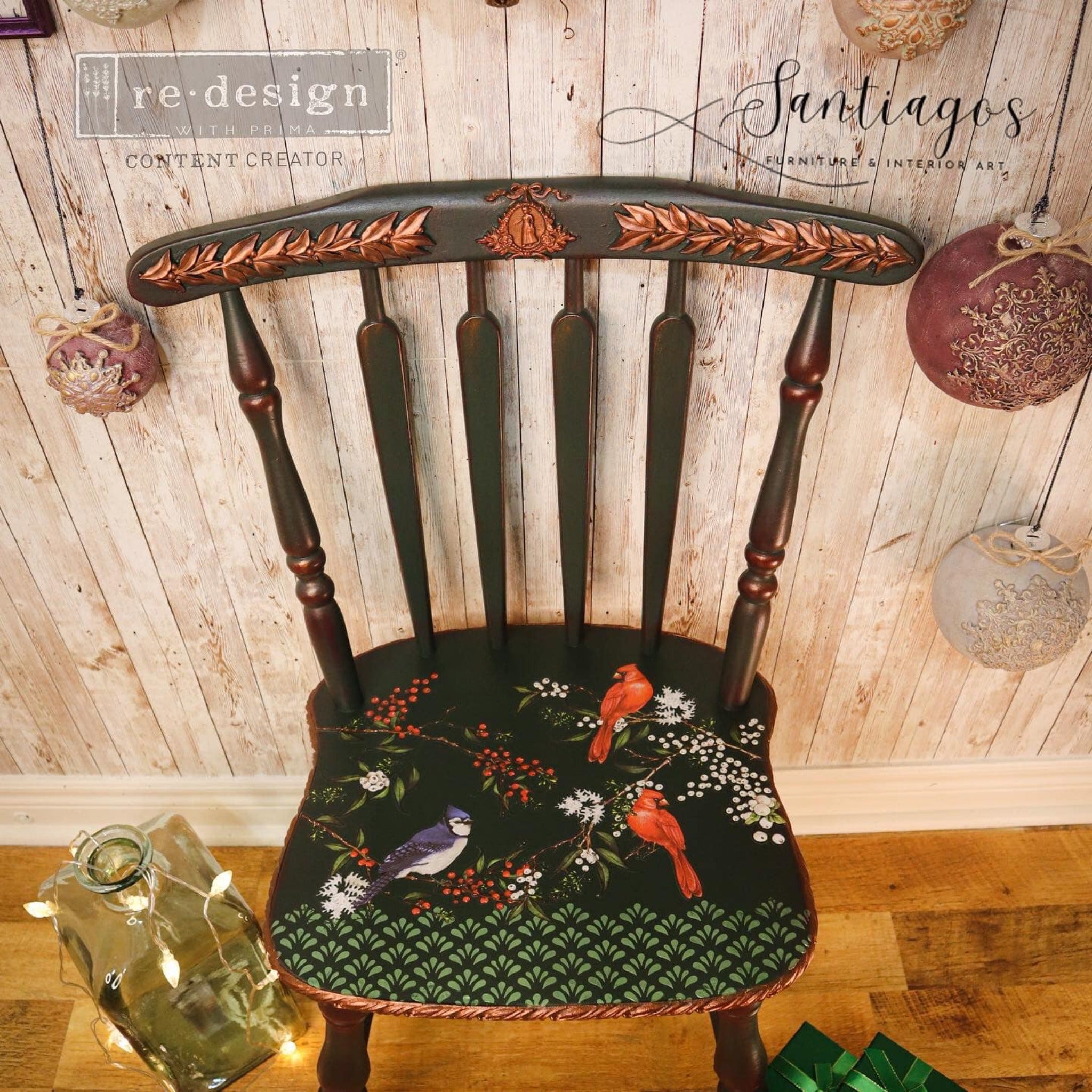 A vintage wood kitchen chair refurbished by Santiago's Furniture Interior Art is painted dark pine green and features ReDesign with Prima's Winterberry small transfer on its seat.