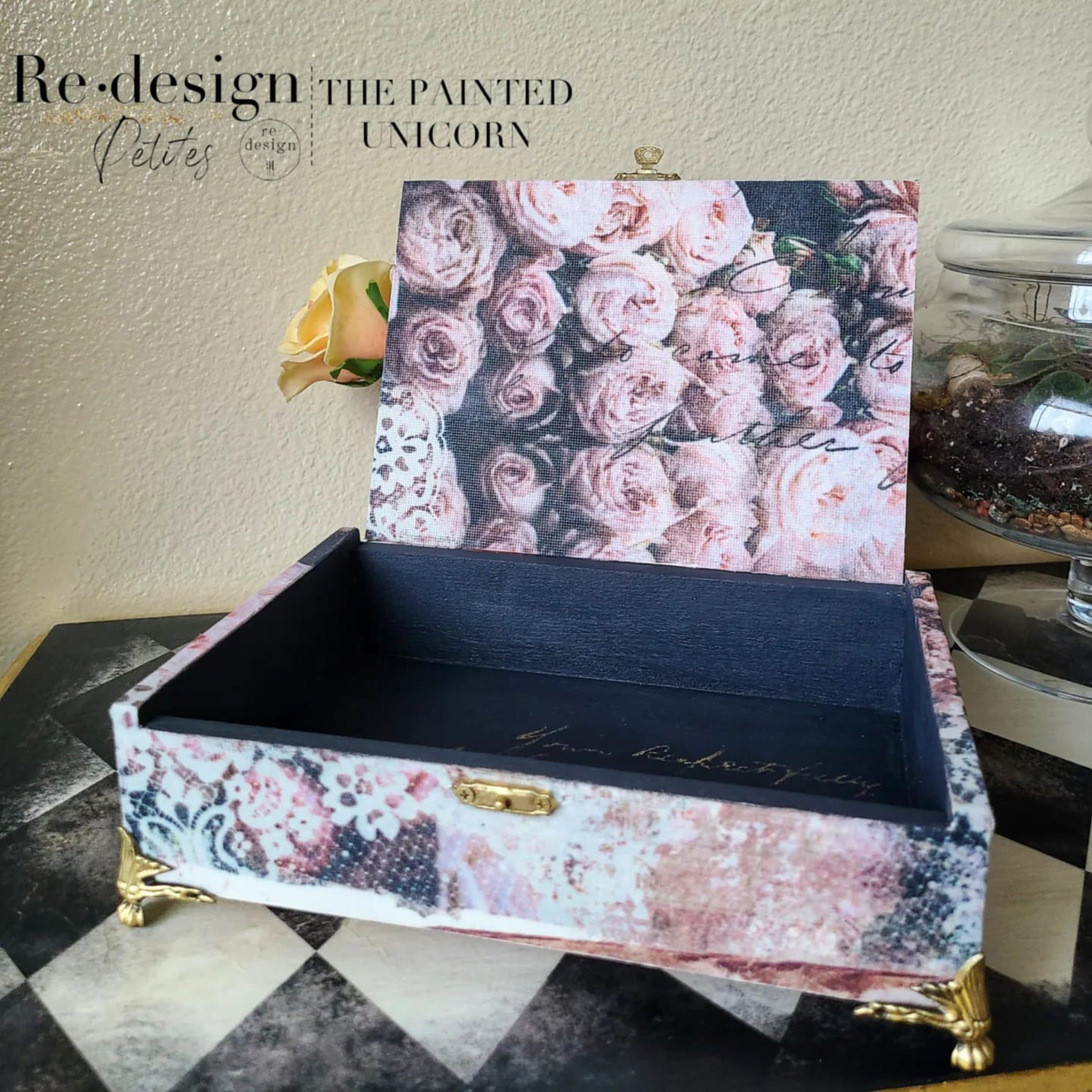 An open box view of a small table top jewelry box refurbished by The Painted Unicorn features ReDesign with Prima's Beautiful Dream tissue paper on the outside and on the inside of the lid.