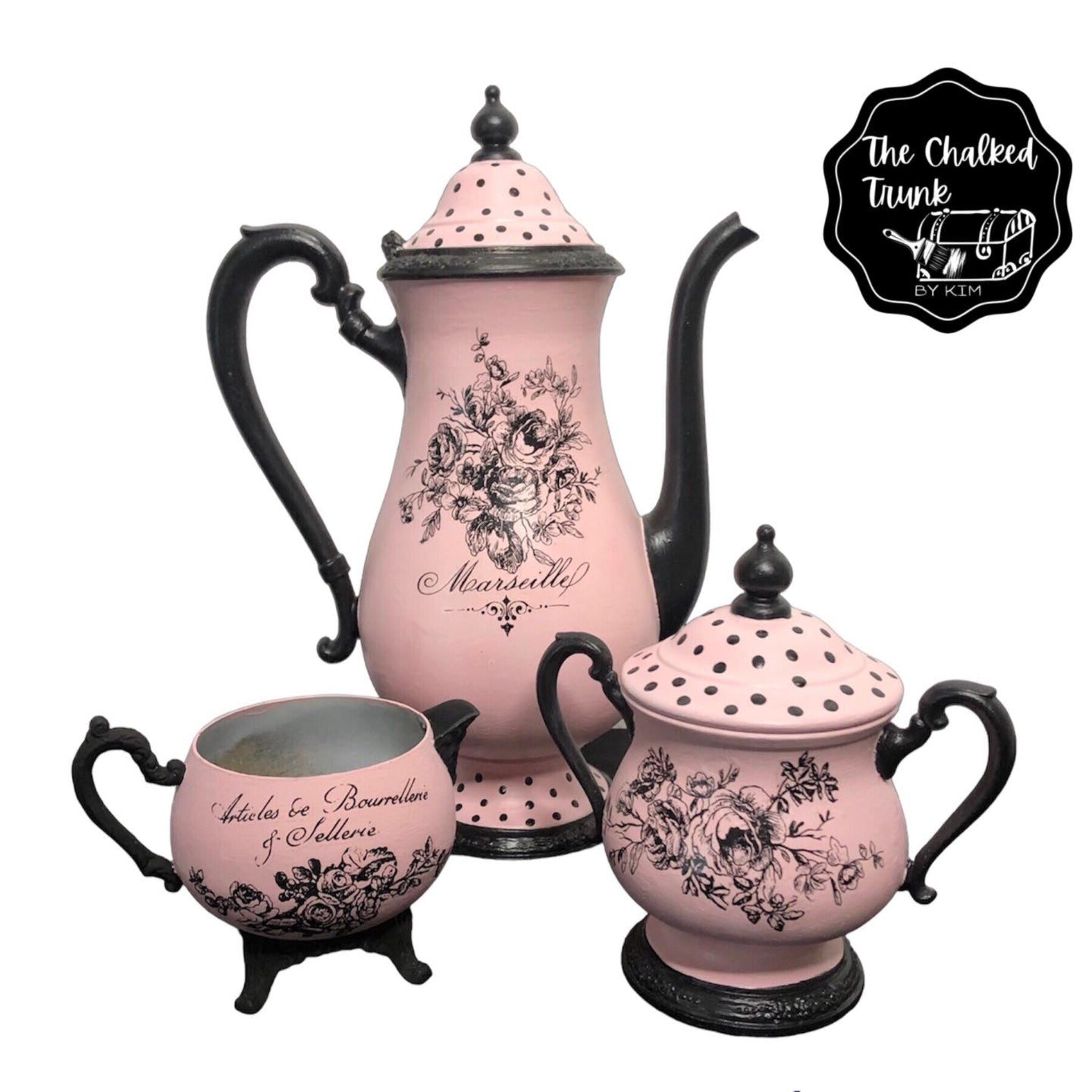 A vintage tea set refurbished by The Chalked Trunk by Kim are painted pale pink and black and features ReDesign with Prima's Classic Vintage Labels transfers on them.