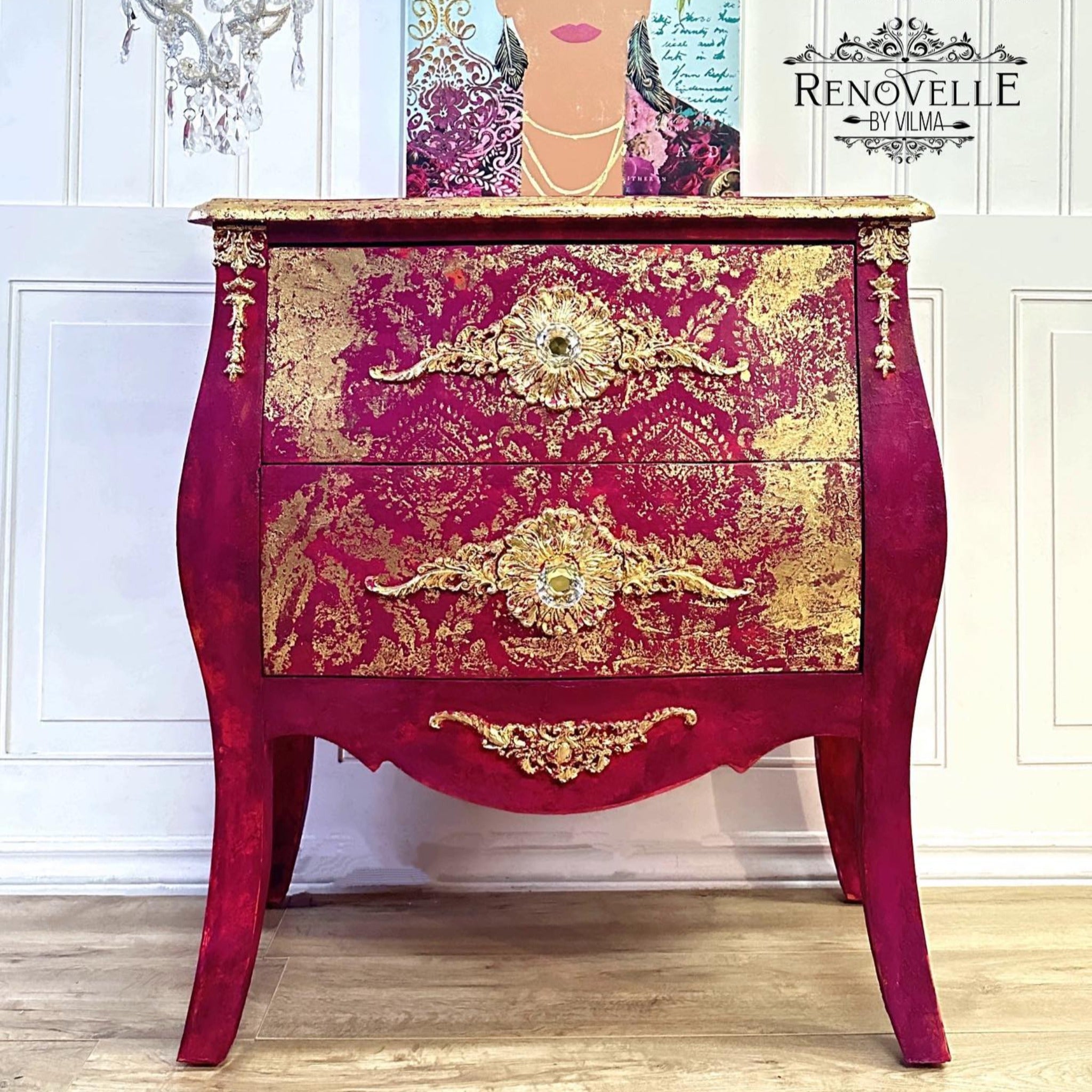 A vintage Bombay style dresser refurbished by Renovelle by Vilma is painted dark red with gold accents and features a piece of ReDesign with Prima's Golden Emblem on the front top left and right side.