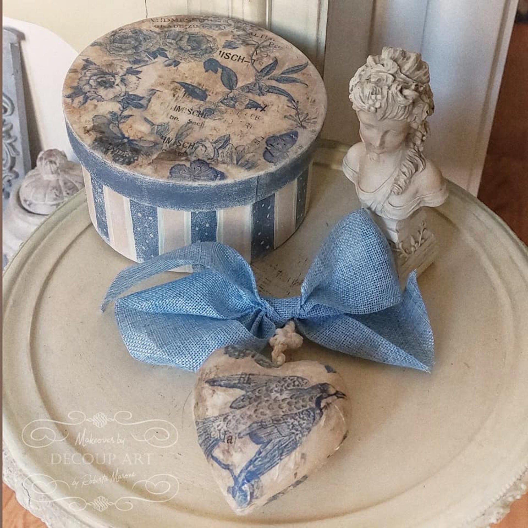 Decoupage Queen's Blue Flight rice paper is featured on a heart craft project. The rice paper is also featured on the top of a round hat box at the top left of the picture.