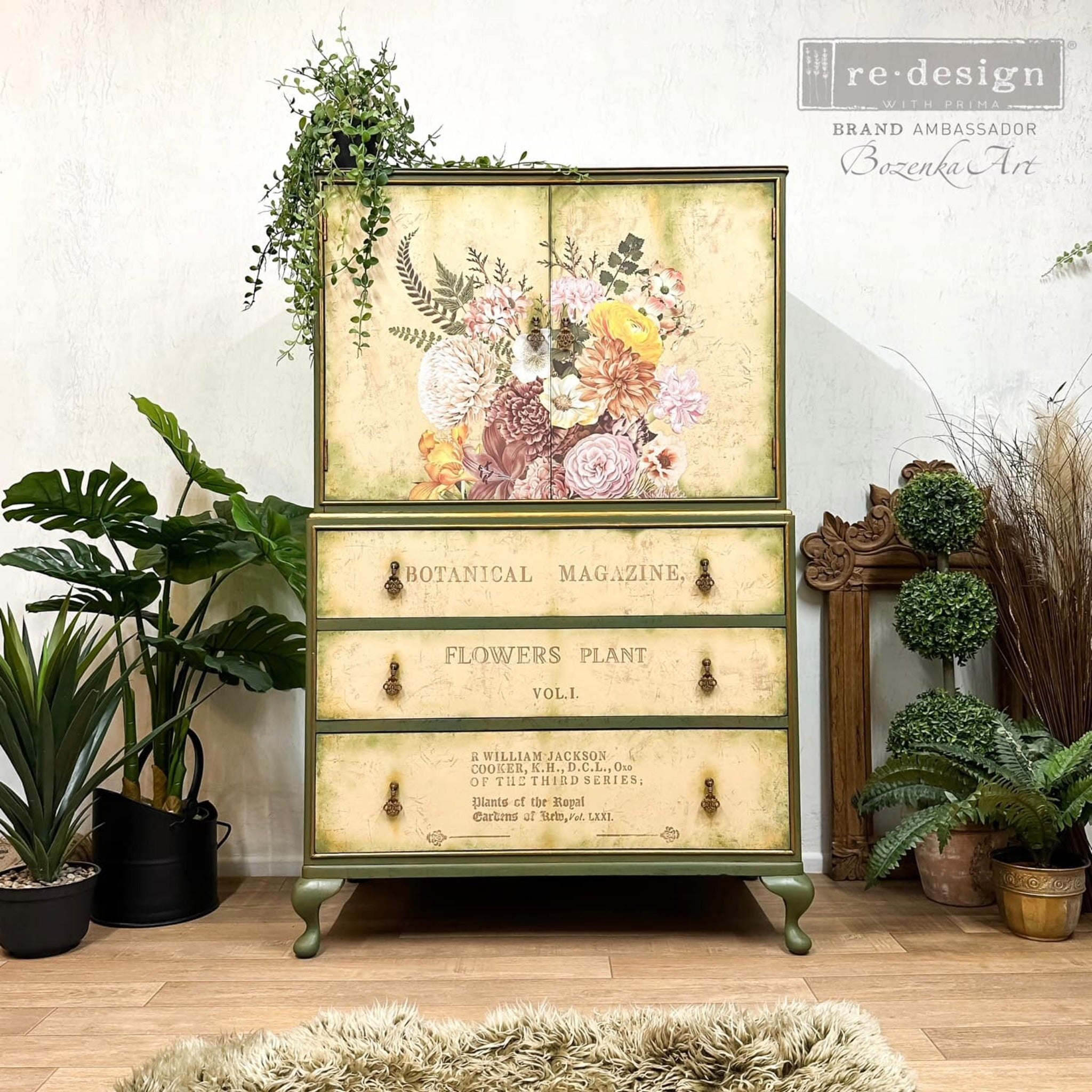 A vintage armoire refurbished by Bozenka Art is painted olive green with beige doors and drawers and features ReDesign with Prima's Kacha Woodland Floral transfer in the center of the 2 doors.