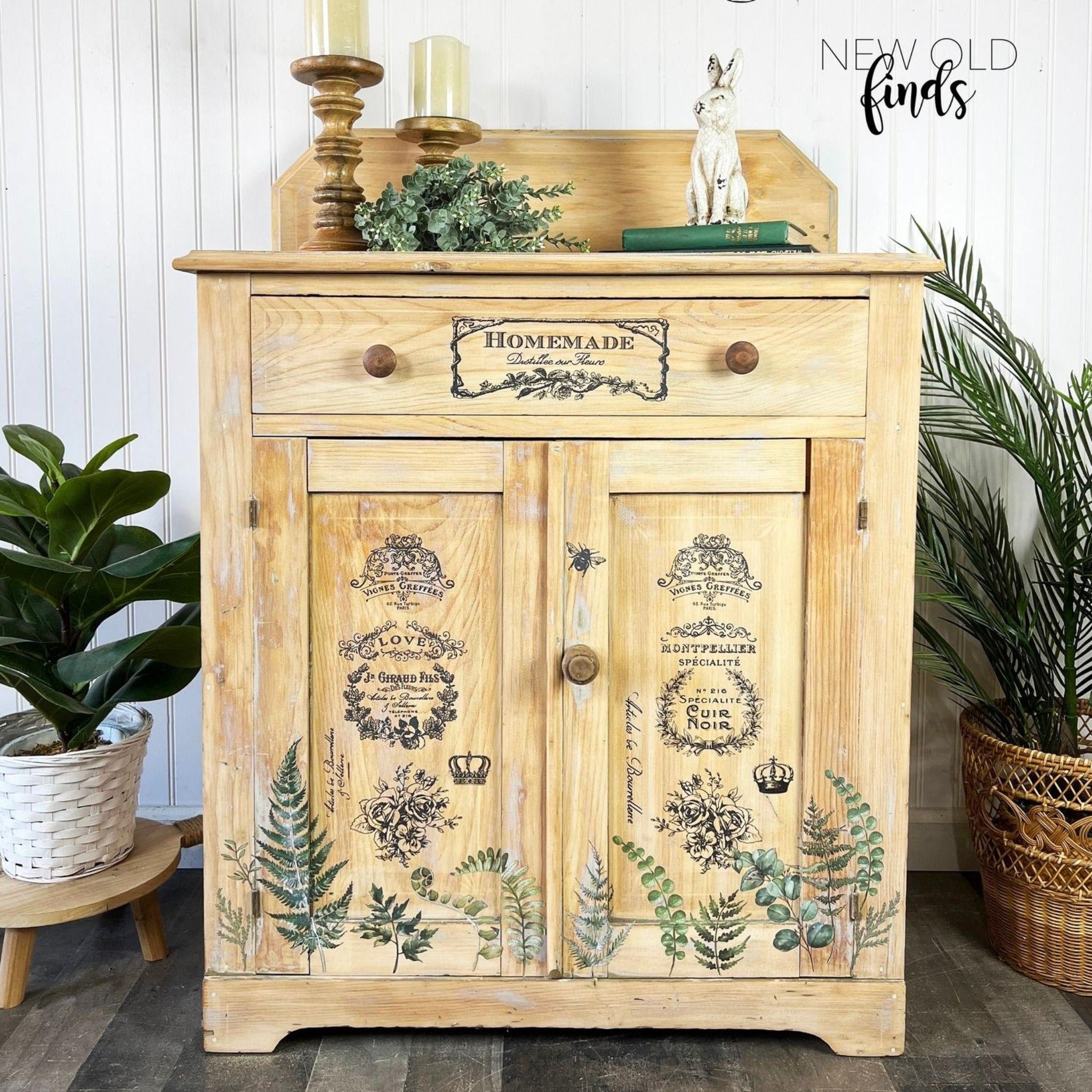 A small natural wood buffet cabinet refurbished by New Old Finds features ReDesign with Prima's French Labels small transfer on the 2 door and 2 drawer.