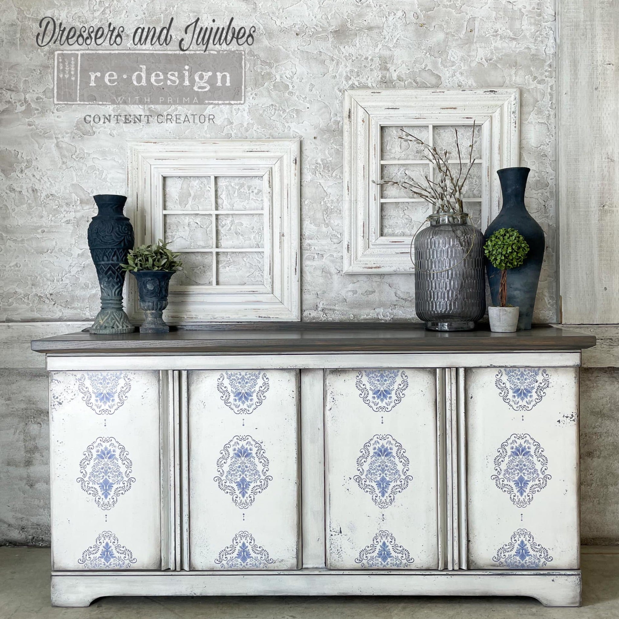 A vintage buffet table refurbished by Dressers and Jujubes is painted white with grey corner smudging and features ReDesign with Prima's Kacha Dana Damask transfer on its 4 doors.