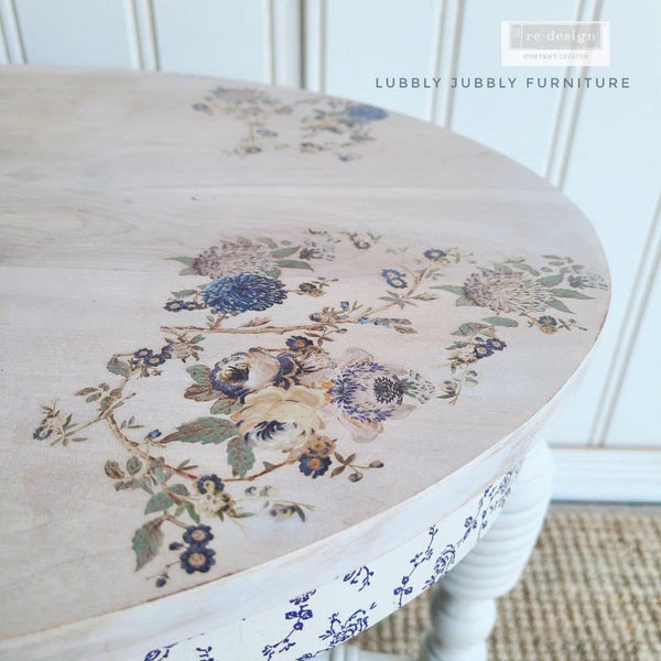 A vintage round table refurbished by Lubbly Jubbly Furniture is painted white and features ReDesign with Prima's Wild Garden Small H2O transfer on it.