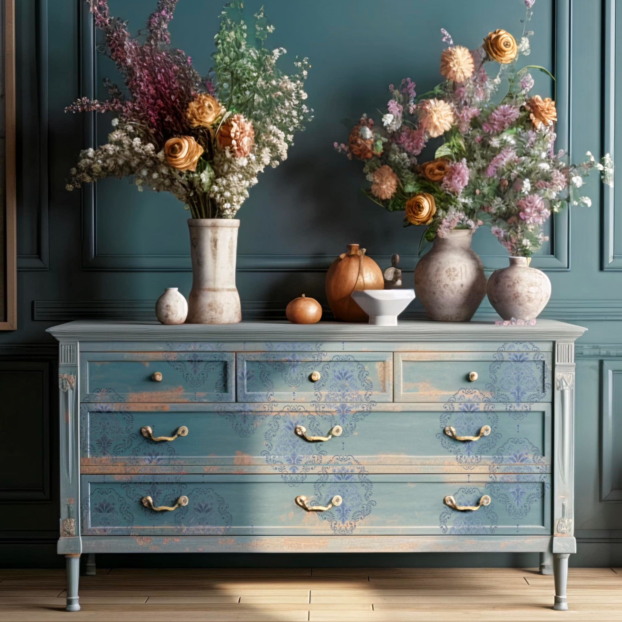 A large dresser is painted a distressed light blue and features ReDesign with Prima's Kacha Dana Damask transfer on its drawers.