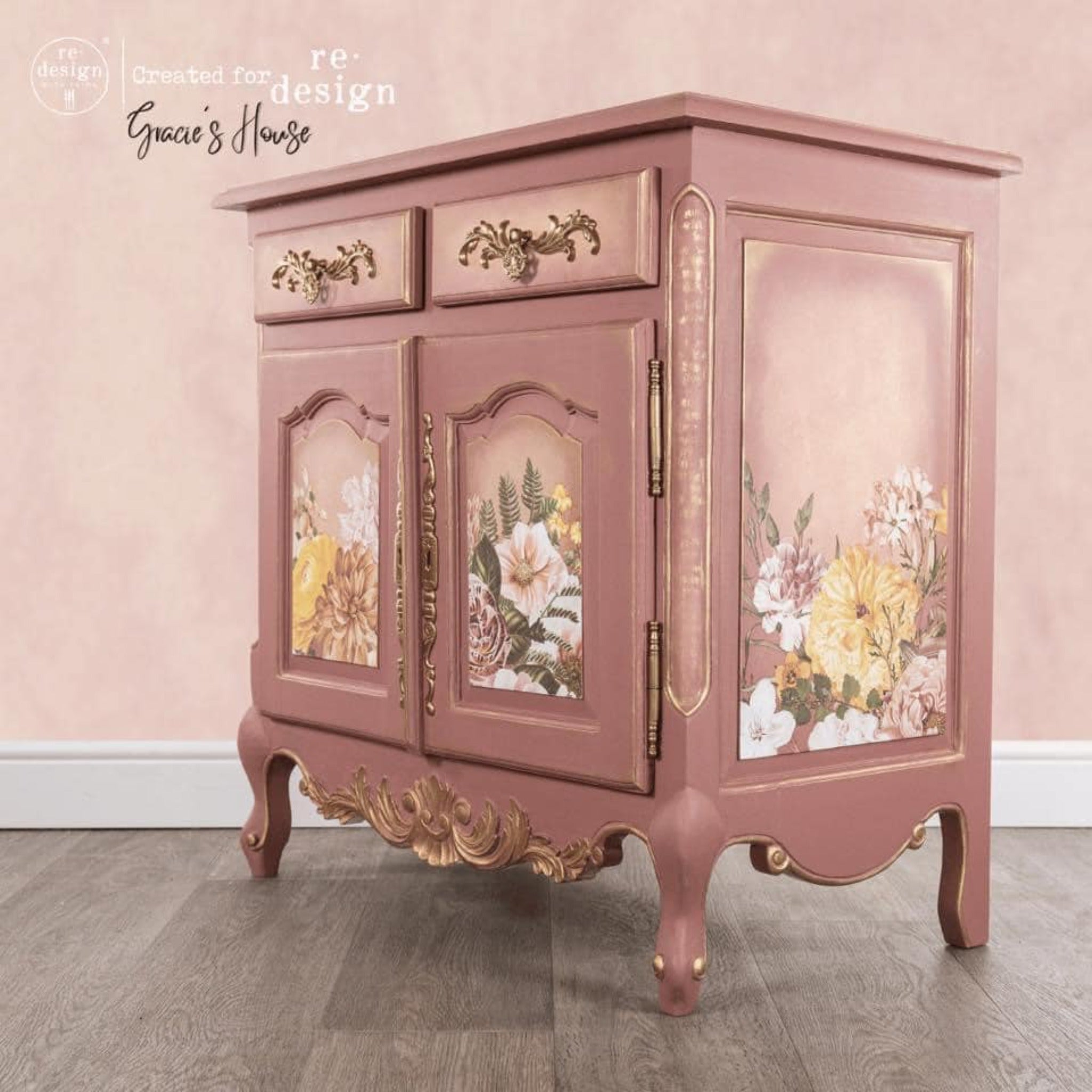 A vintage small buffet table refurbished by Gracie's House is painted mauve pink and features ReDesign with Prima's Kacha Woodland Floral transfer on its 2 door inlays and the side panel inlay.