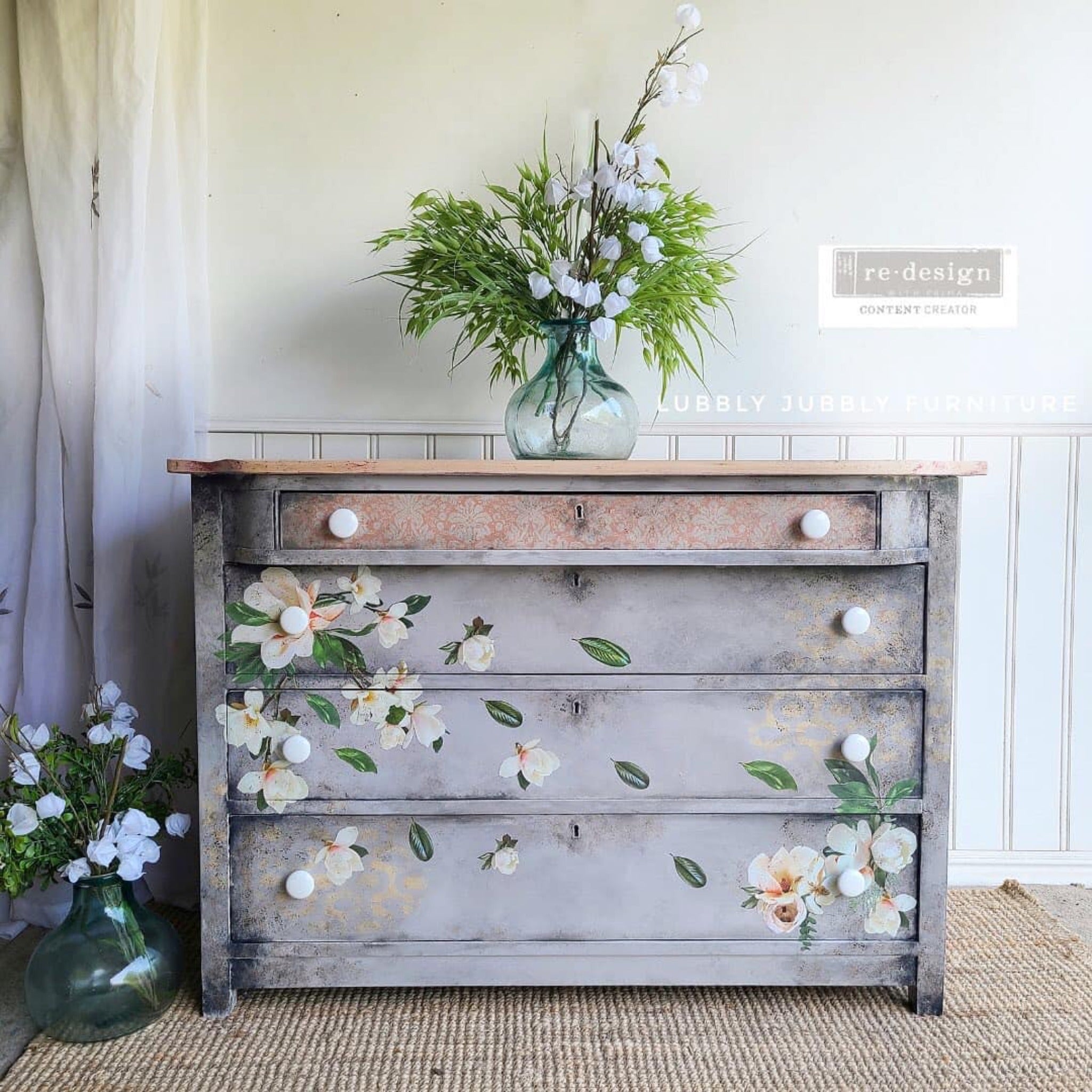 A vintage dresser refurbished by Lubbly Jubbly Furniture is painted light grey with sponged on areas of beige and dark grey. ReDesign with Prima's Peach Damask tissue paper is featured on a thin top drawer face.