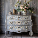 A vintage 3-drawer dresser is painted a distressed ight grey and features ReDesign with Prima's Albery transfer on its drawers.