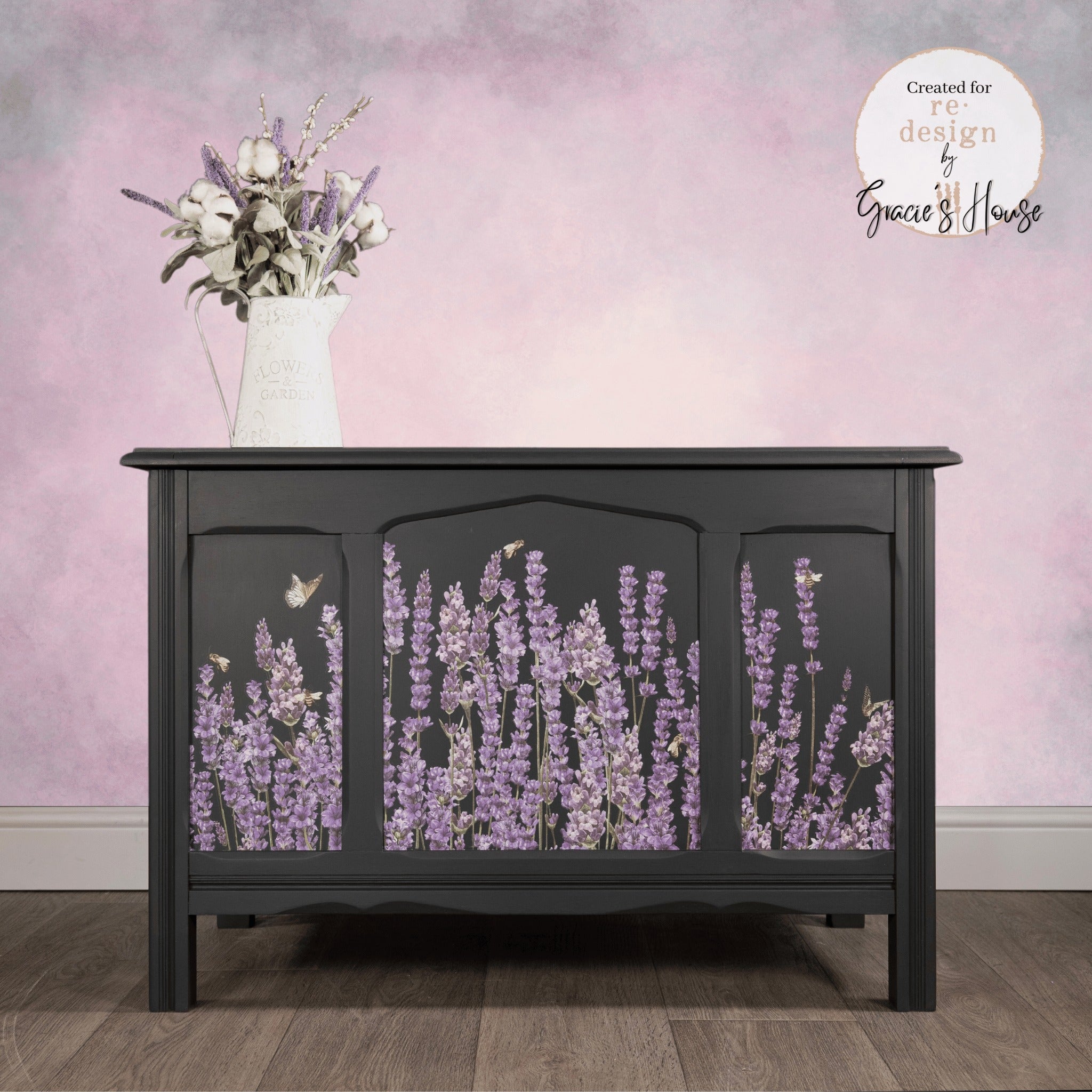 A vintage console table refurbished by Gracie's House is painted flat black and features ReDesign with Prima's Champs de Lavende transfer on the front.