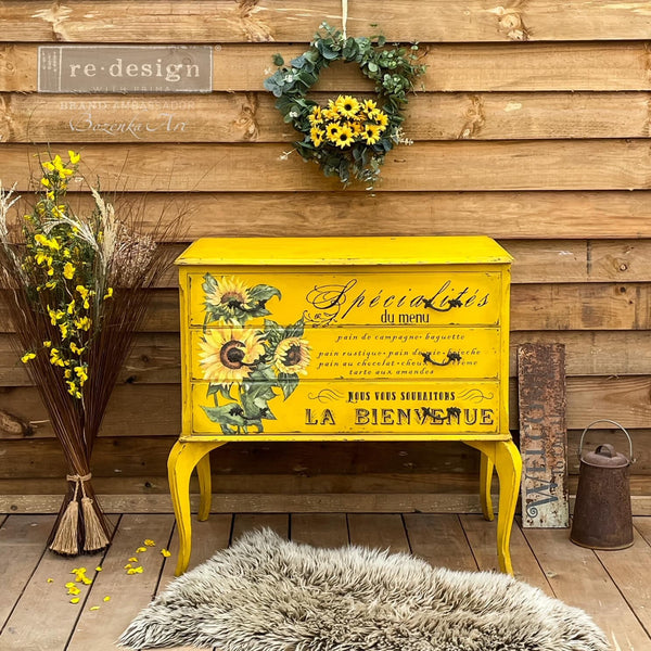 A vintage 3-drawer nightstand refurbished by Bozenka Art is painted bright yellow and features ReDesign with Prima's Sunflower transfer on its drawers.