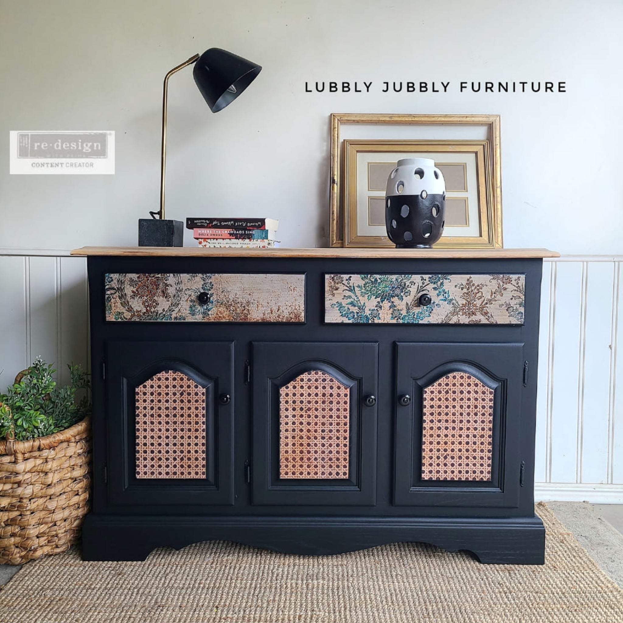 A buffet table refurbished by Lubbly Jubbly Furniture is painted black with a natural wood top and features ReDesign with Prima's Rustic Patina tissue paper on its 2 drawers.