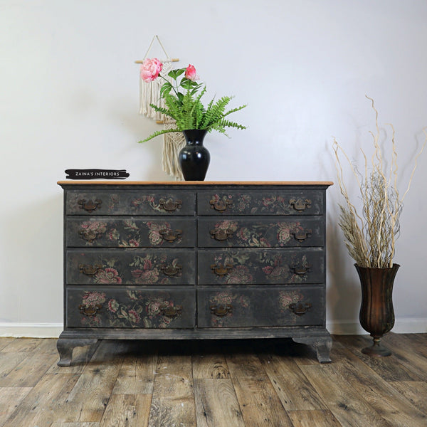 A vintage 8 drawer dresser refurbished by Zaina's Interiors is painted a distressed black and features a distressed application of ReDesign with Prima's Floral Paisley tissue paper on its drawers.