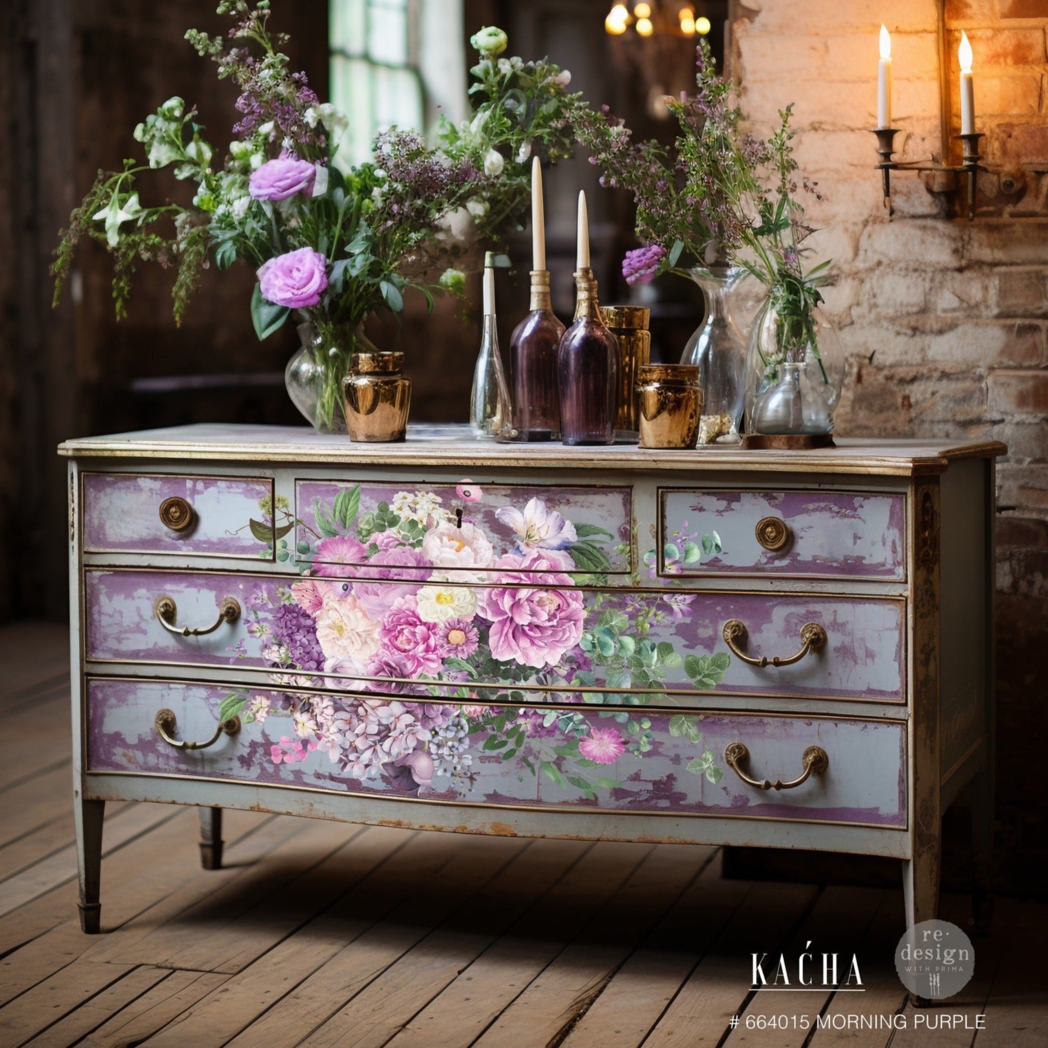 A large vintage dresser is painted a blend of light blue and lavender and features ReDesign with Prima's Kacha Morning Purple transfer in the center of the front of the drawers.