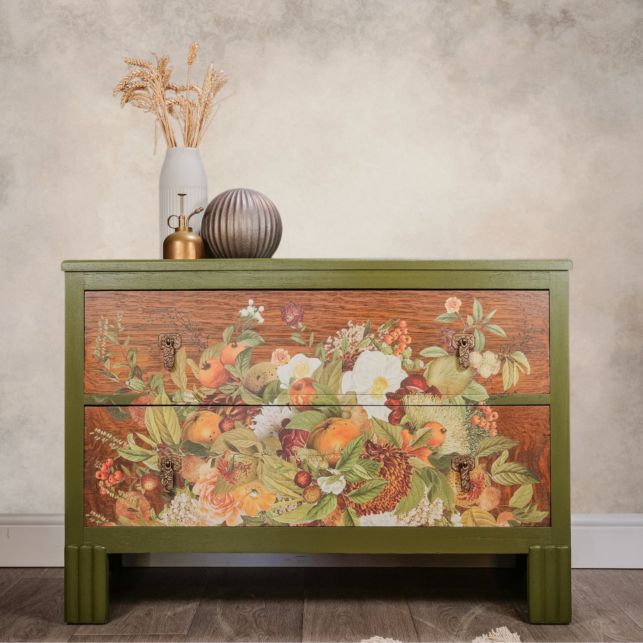 A short 2-drawer dresser is painted olive green with natural wood drawers and features ReDesign with Prima's Harvest Hues transfer on the drawers.