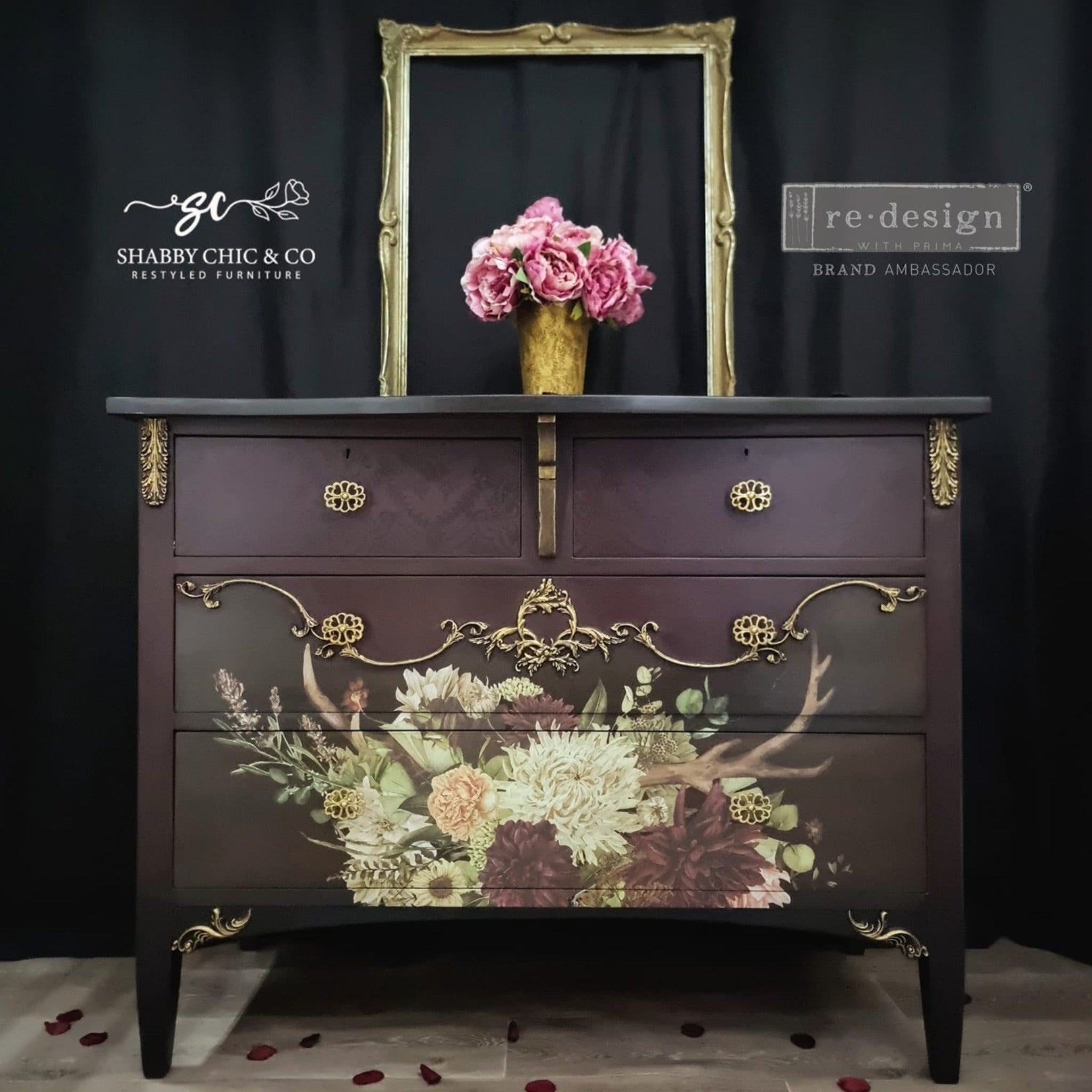 A 4 drawer dresser refurbished by Shabby Chic & Co. is painted a dark black cherry with gold accents and features ReDesign with Prima's Prairie House 12"x12" transfer on the bottom 2 large drawers.
