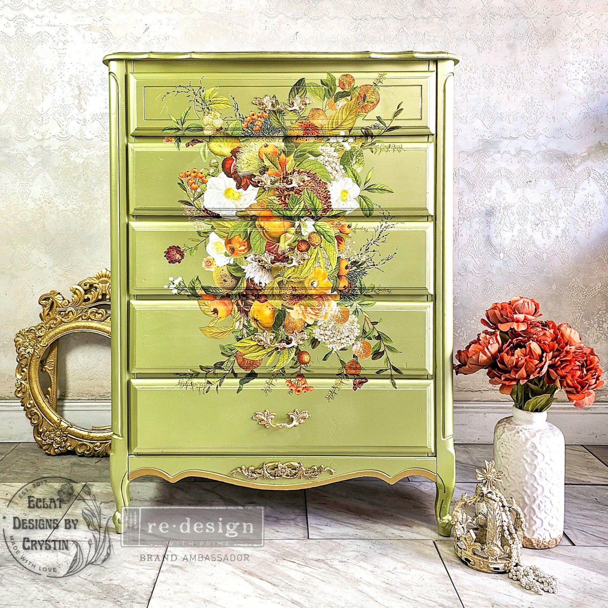 A 5-drwer chest dresser refurbished by Eclat Designs by Crystin is painted Spring green and features ReDesign with Prima's Harvest Hues transfer down the center of its top 4 drawers.