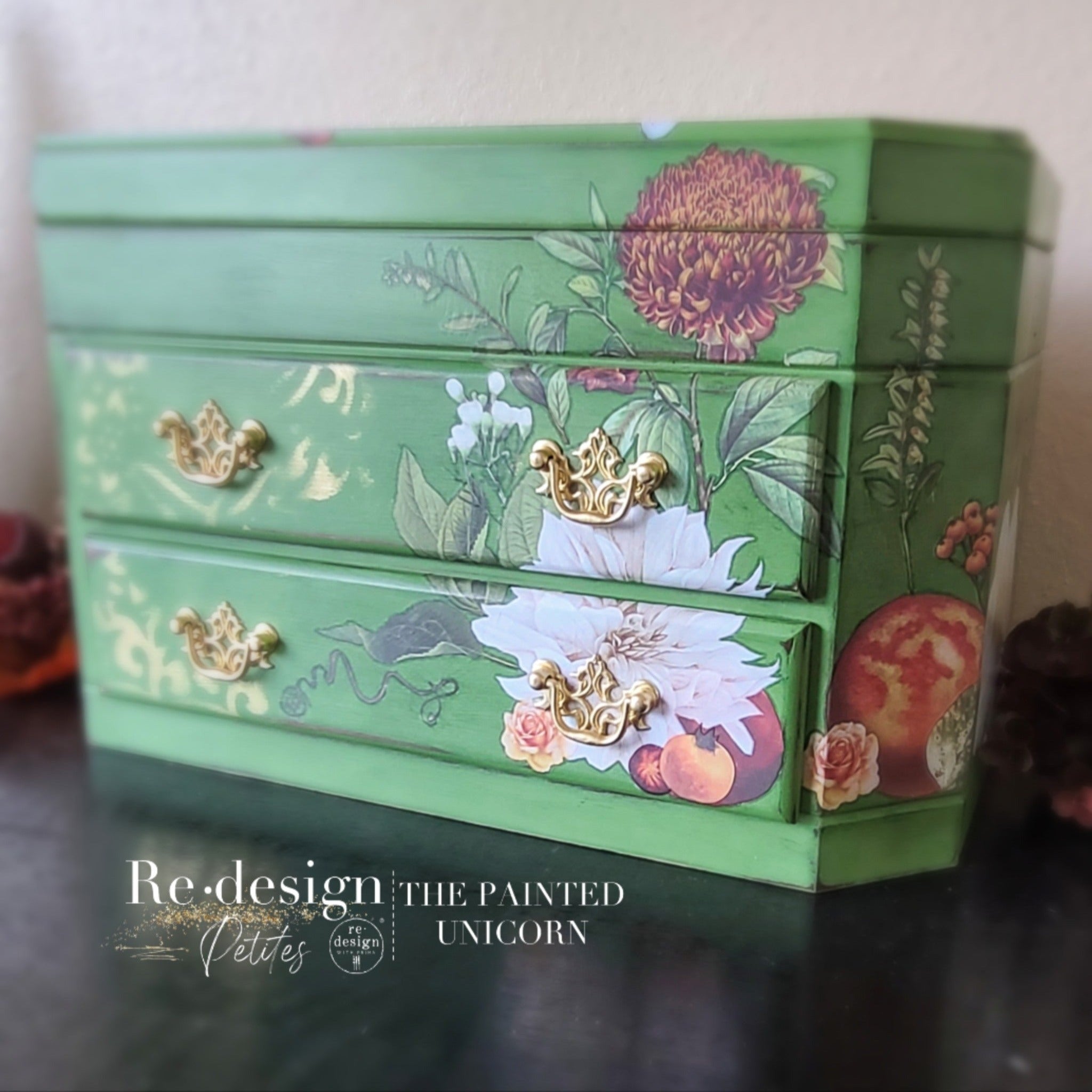 A small vintage jewelry box refurbished by The Painted Unicorn is painted Spring green and features ReDesign with Prima's Seasonal Splendor small transfer on it.