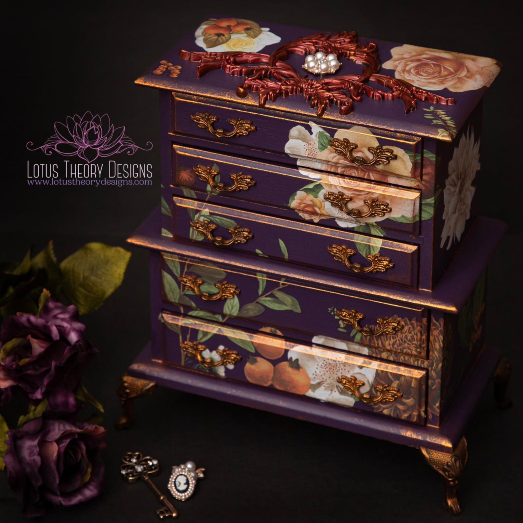 A tabletop jewelry box refurbished by Lotus Theory Designs is painted royal purple and features ReDesign with Prima's Seasonal Splendor small transfer on it.