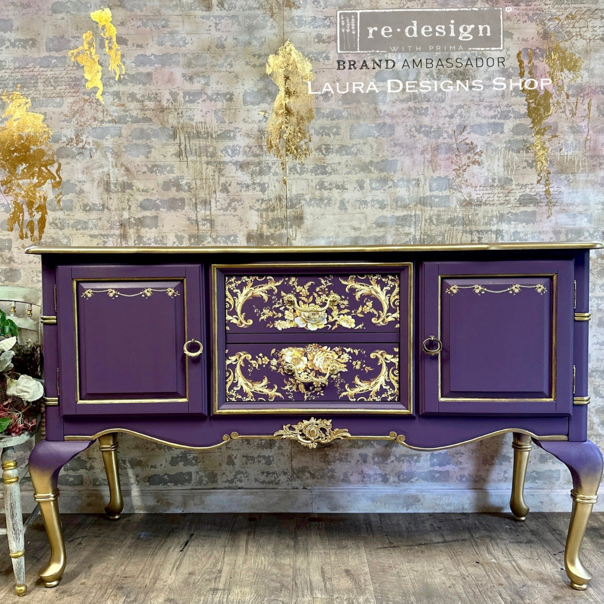 A vintage buffet table refurbished by Laura Designs Shop is painted a deep royal purple with gold accents and features ReDesign with Prima's Kacha Orleans transfer on the 2 center drawers.