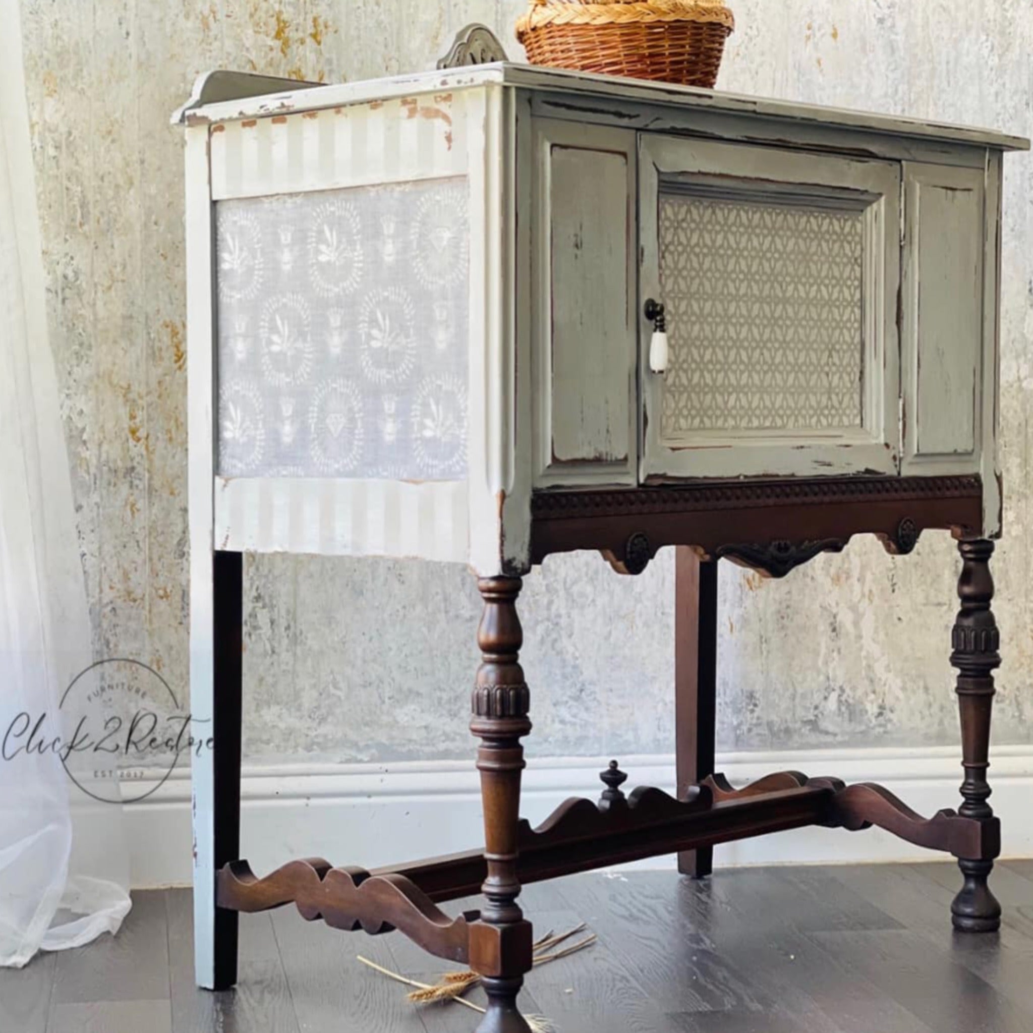A vintage console table with storage refurbished by Click 2 Restore is painted antique white with brown legs and features ReDesign with Prima's Delicate Charm tissue paper on the side.