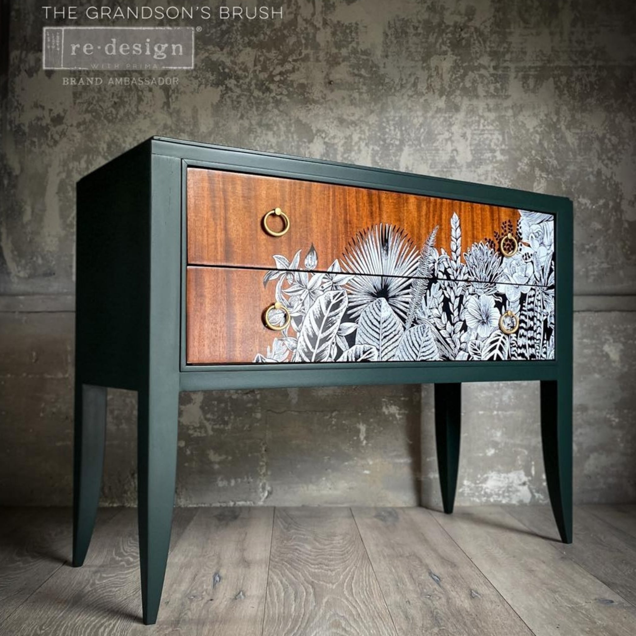 A modern 2-drawer nightstand refurbished by The Grandson's Brush is painted dark green and features ReDesign with Prima's Abstract Jungle transfer on its drawers over natural wood.