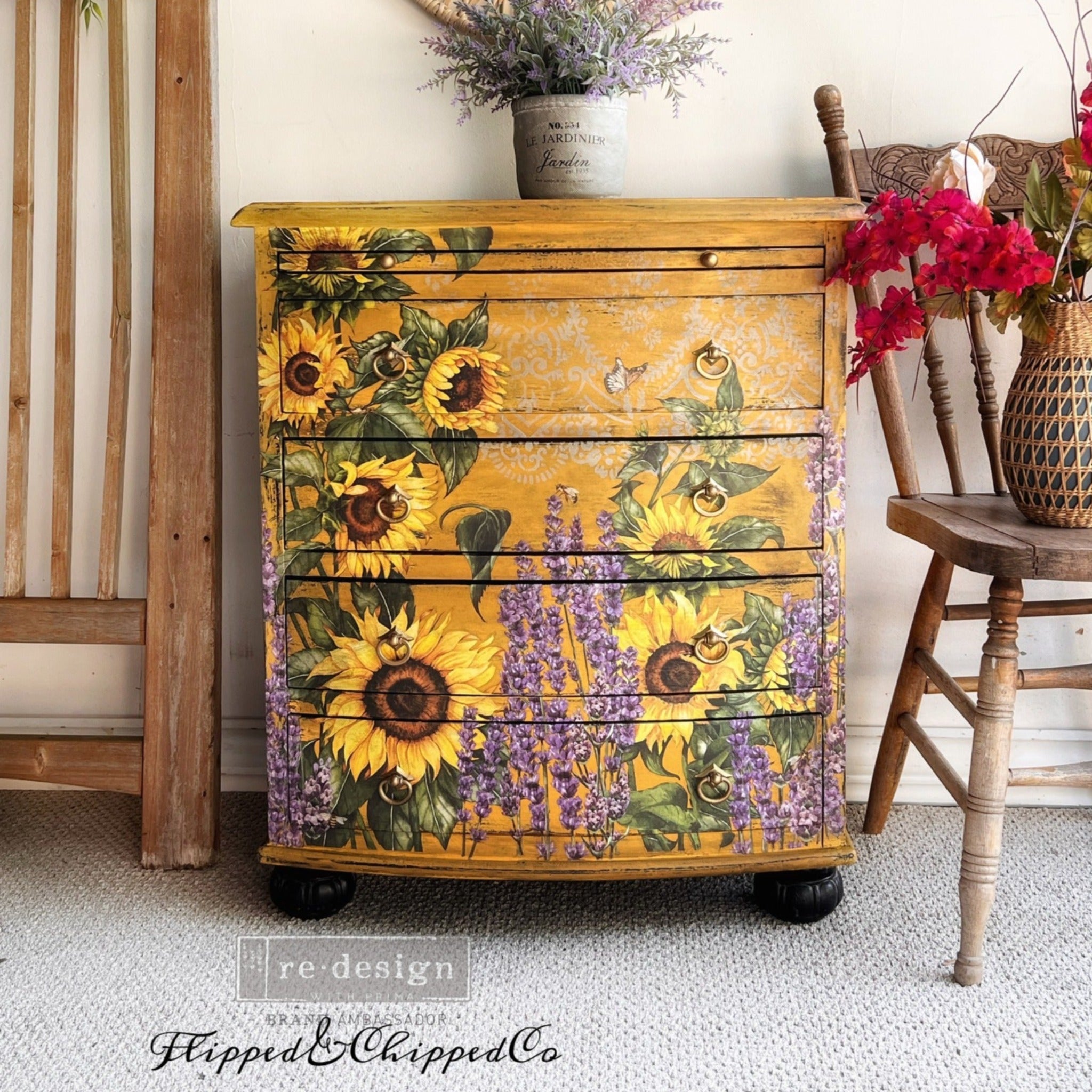 A chest dresser refurbished by Flipped & Chipped is painted mustard yellow and features ReDesign with Prima's Champs de Lavende transfer along with a sunflower transfer on the front of it.