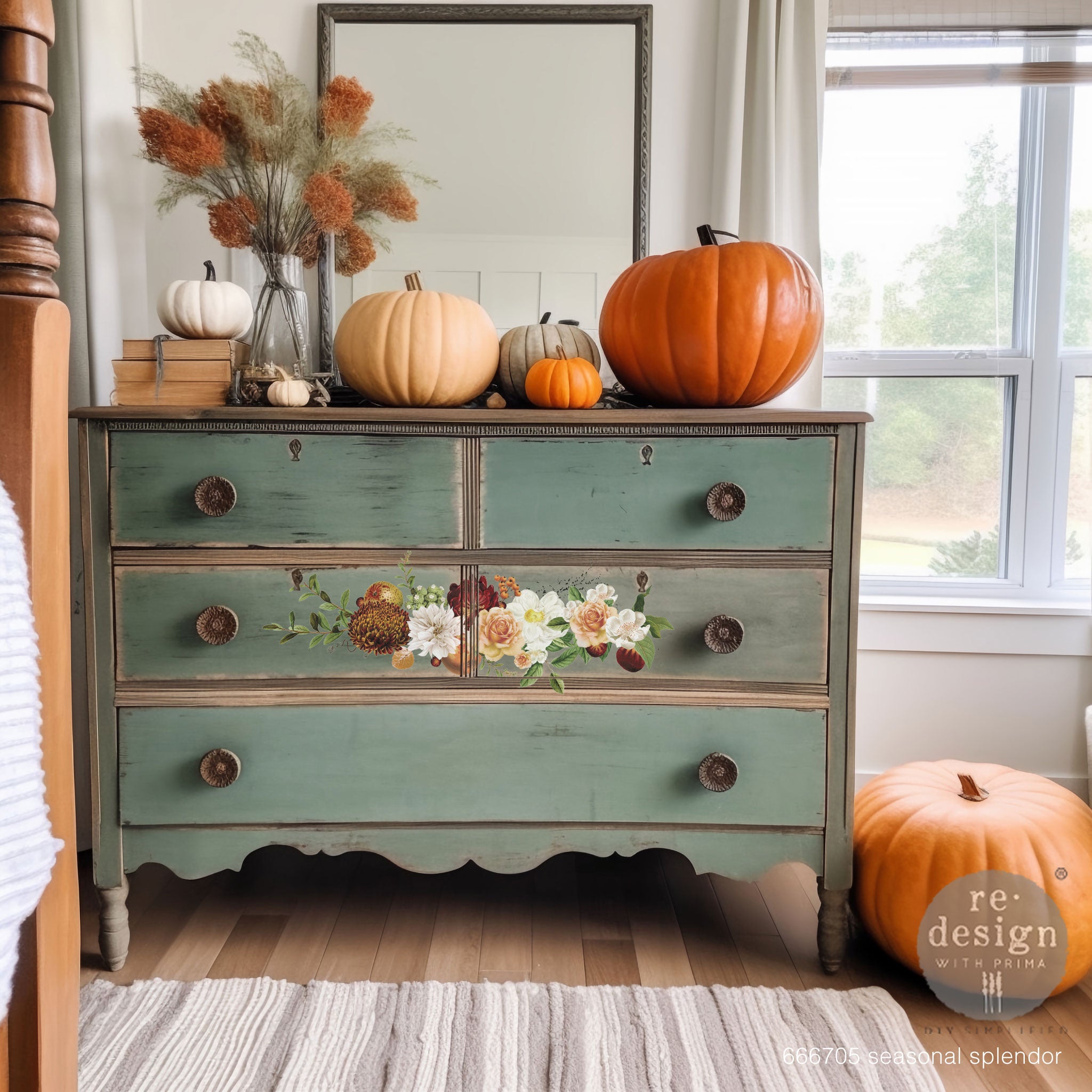 A vintage dreser is painted a soft green and features ReDesign with Prima's Seasonal Splendor small transfer arranged into a bouquet in the center of the front of the dresser.