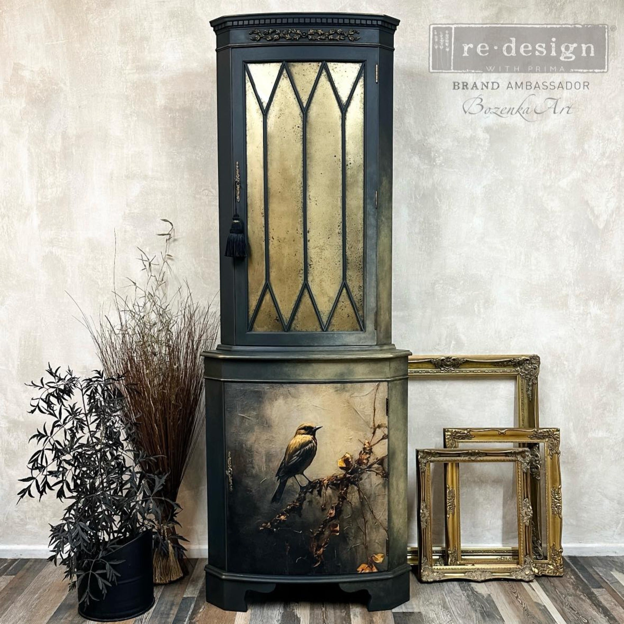 A vintage curio hutch refurbished by Bozenka Art is painted black with gold accents and features ReDesign with Prima's Rustic Refuge A1 fiber paper on its bottom door.
