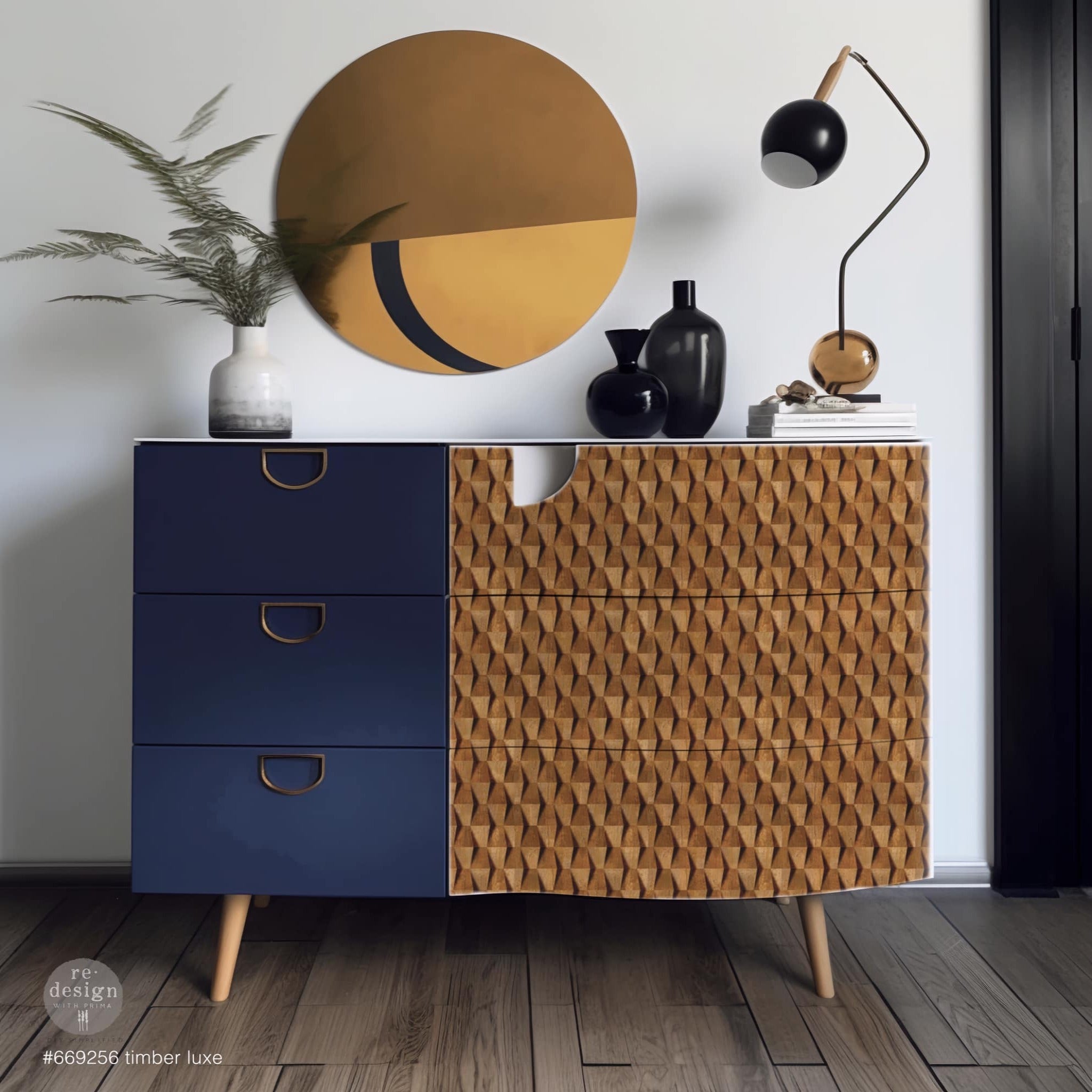 A mid-century 6-drawer dresser has 3 navy blue small drawers to the left and 3 larger drawers on the right that feature ReDesign with Prima's Timber Luxe A1 fiber paper.