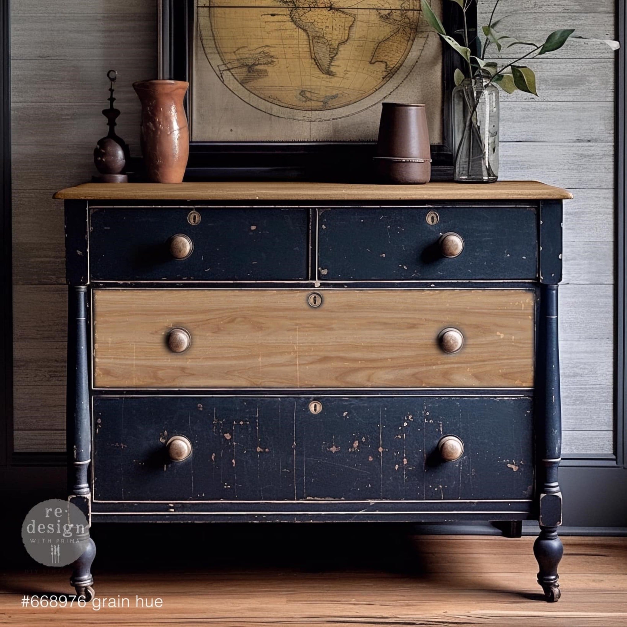 A vintage 4-drawer dresser is painted dark navy blue and features ReDesign with Prima's Grain Hue A1 fiber paper on the drawer in the middle.