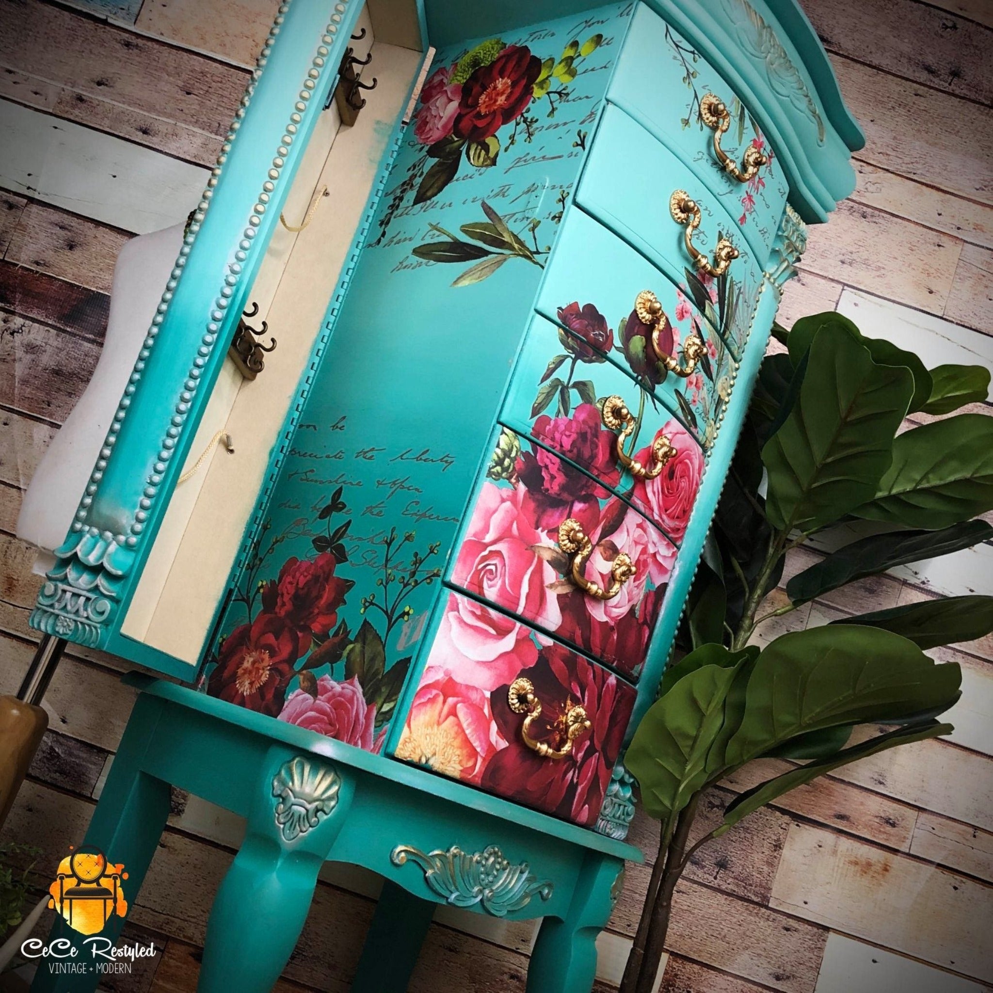 A vintage standing jewelry armoire refurbished by CeCe ReStyled is painted an ombre of light teal down to dark teal with gold accents and features ReDesign with Prima's Royal Burgundy transfer on its front drawers and inside its side door.