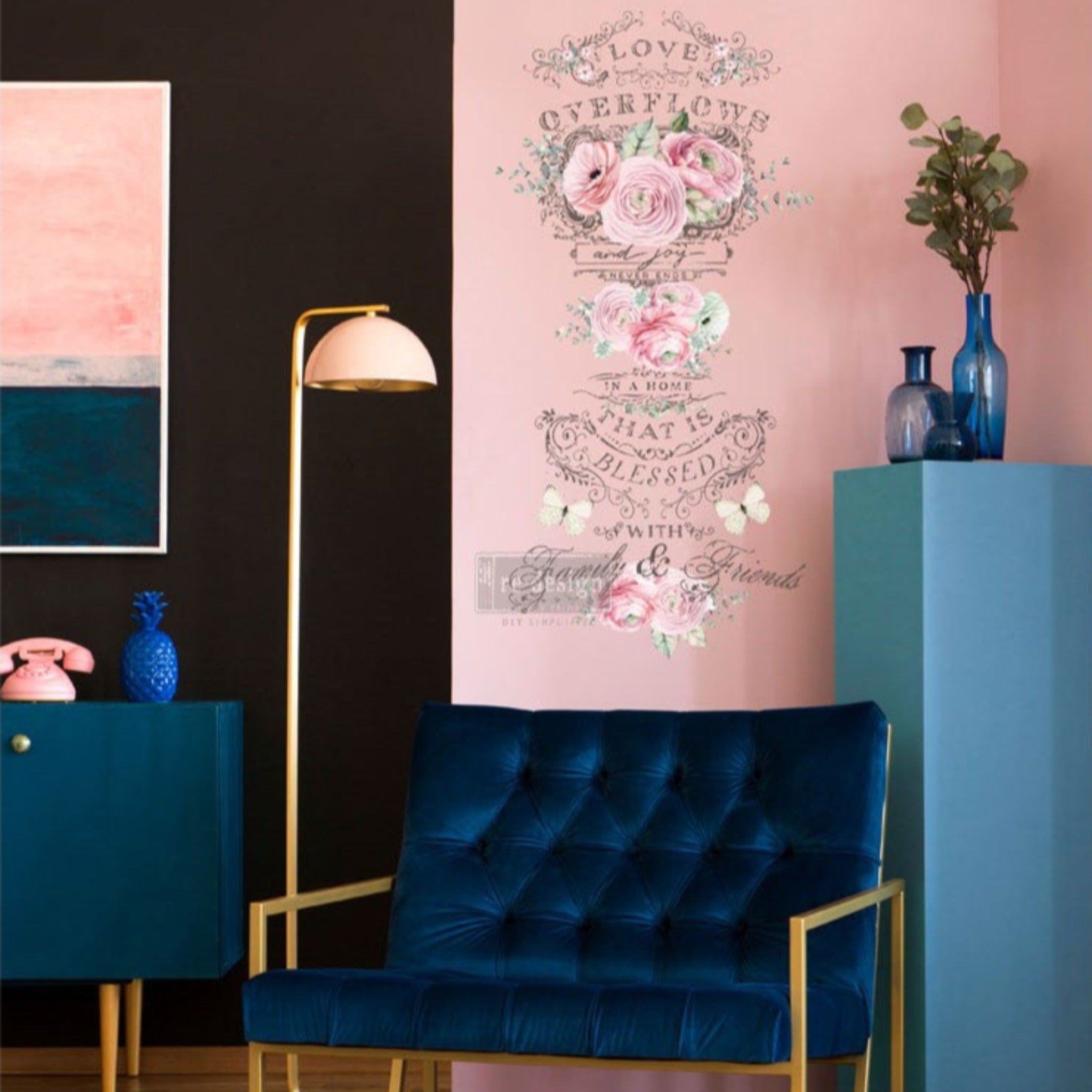 ReDesign with Prima's Overflowing Love transfer is featured on a light pink wall behind a midcentury blue velvet sitting chair.