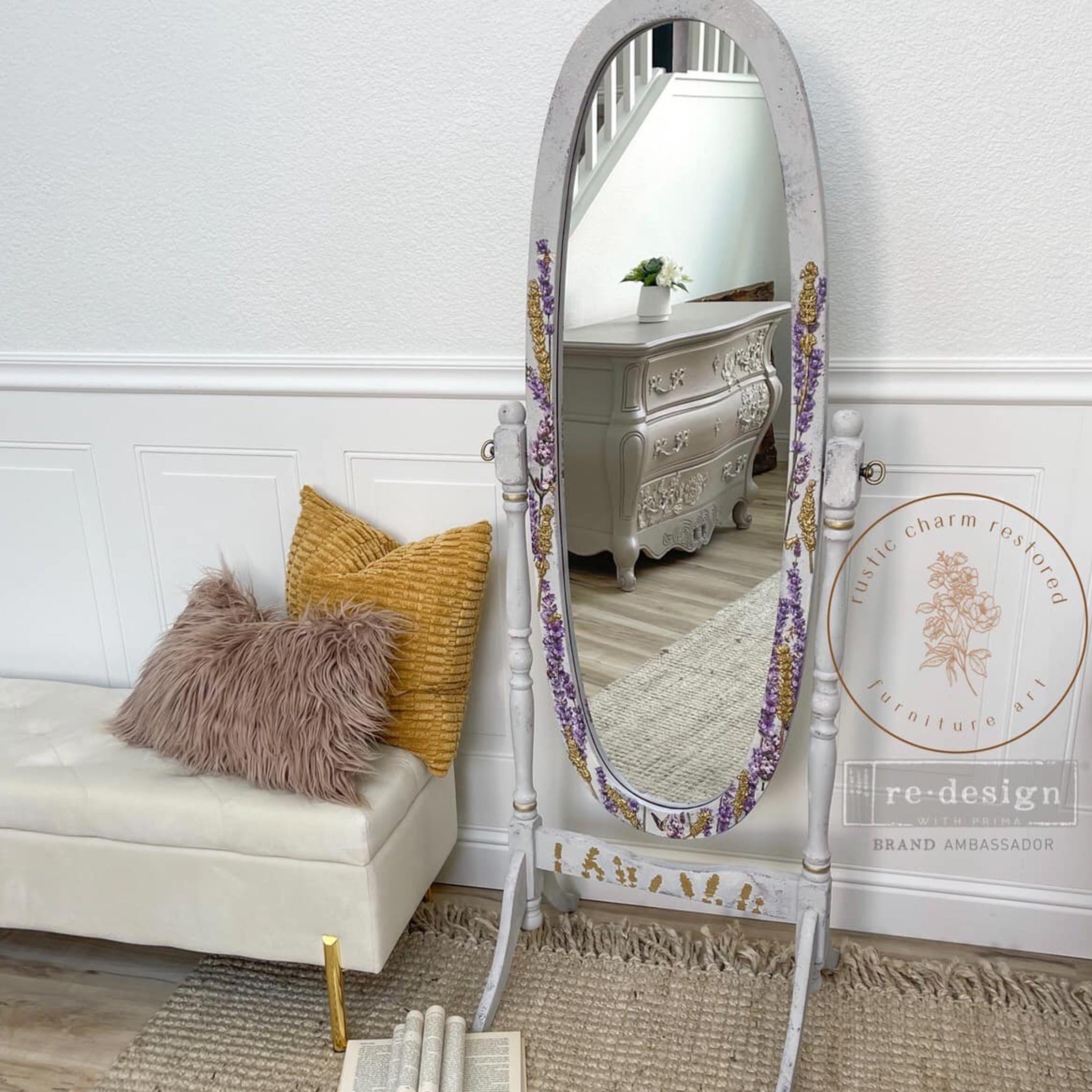 A vintage standing mirror refurbished by Rustic Charm Restored Furniture Art is painted light grey and features ReDesign with Prima's Champs de Lavende transfer and gold painted lavender silicone mould castings on the frame.