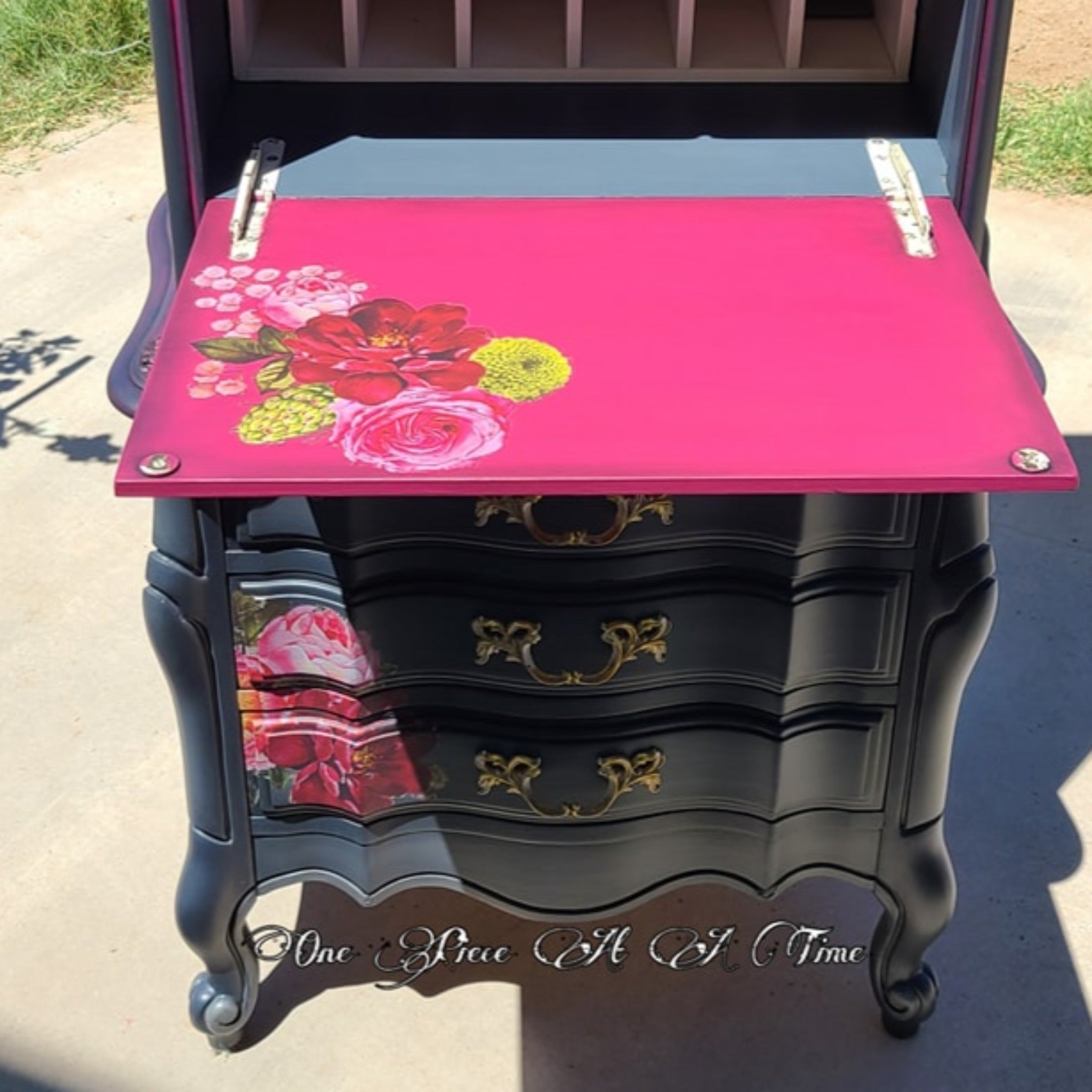 A vintage French Provencial hutch refurbished by One Piece At A Time is painted black and deep pink and features ReDesign with Prima's Royal Burgundy transfer on its drawers and the inside of its drop-down door.