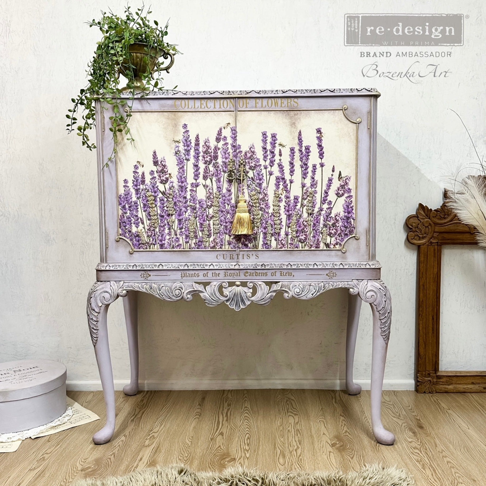 A vintage end table with storage refurbished by Bozenka Art is painted purple-grey and features ReDesign with Prima's Champs de Lavende transfer on its 2 door inlays.