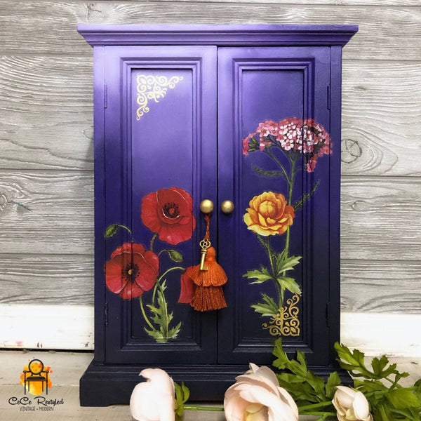 A vintage armoire refurbished by CeCe ReStyled is painted am ombre blend of light to dark blue and features ReDesign with Prima's Poppy Gardens transfer on it.